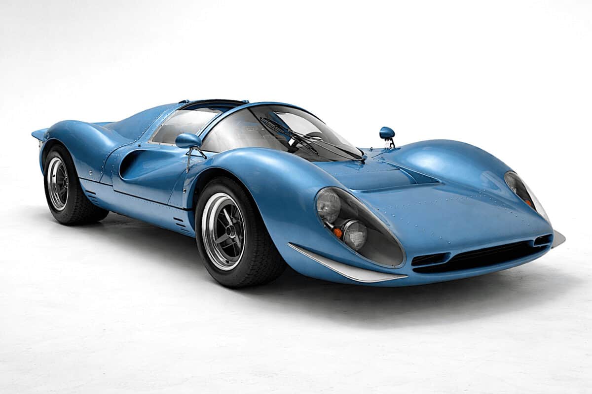 A sleek blue vintage race car with aerodynamic design, exterior view.