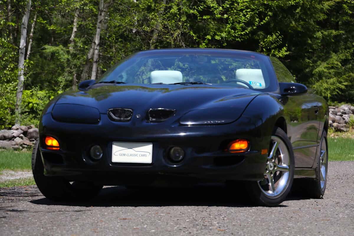 Exterior shot of a sleek black Mazda MX-5 convertible parked outdoors.
