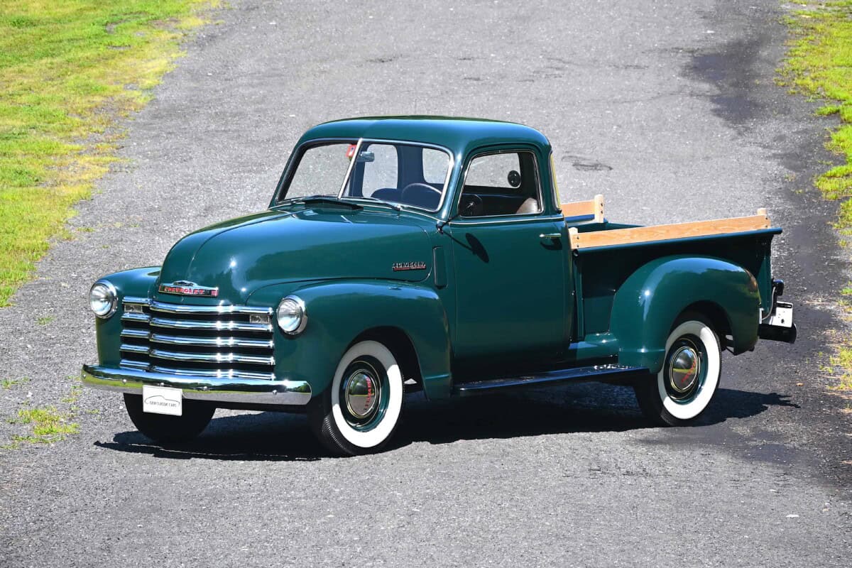 Exterior shot of a vintage Chevrolet pickup truck on a rural road.