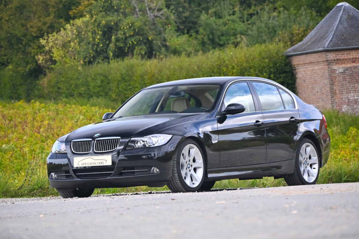 Exterior shot of a black BMW sedan parked outdoors.