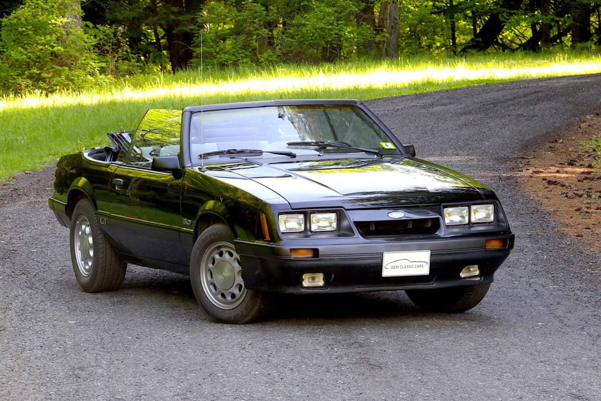 Exterior shot of a vintage black convertible car parked outdoors.