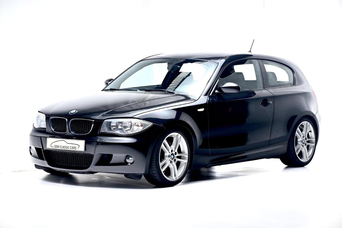 Black BMW 1 Series hatchback front exterior view.
