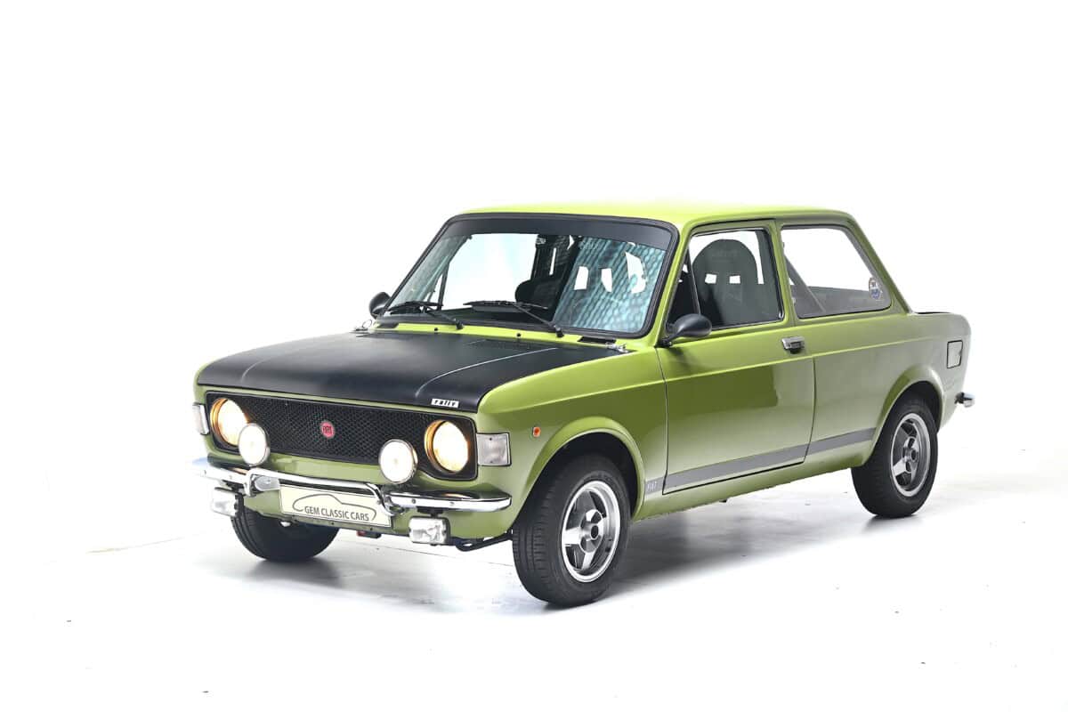 Classic green vintage car, front exterior shot, detailed view.