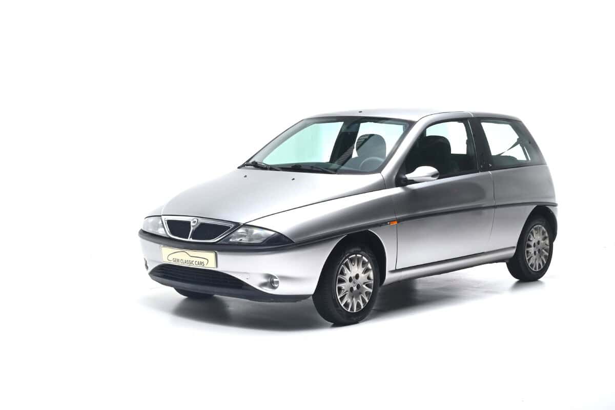 Silver hatchback car, exterior view, compact city vehicle.