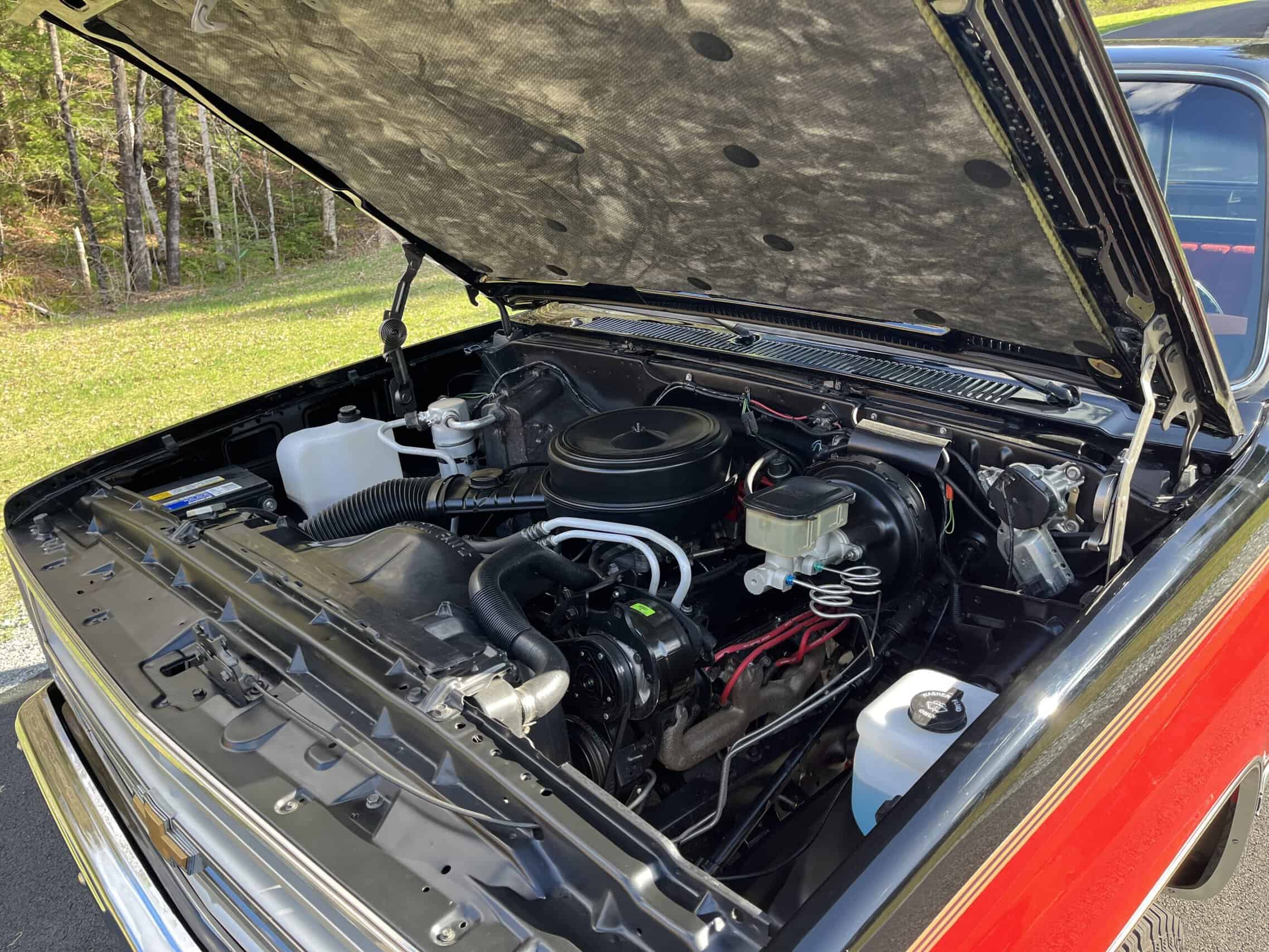 1986 Chevrolet SILVERADO — Exterior shot of a classic car engine with open hood showing engine components.