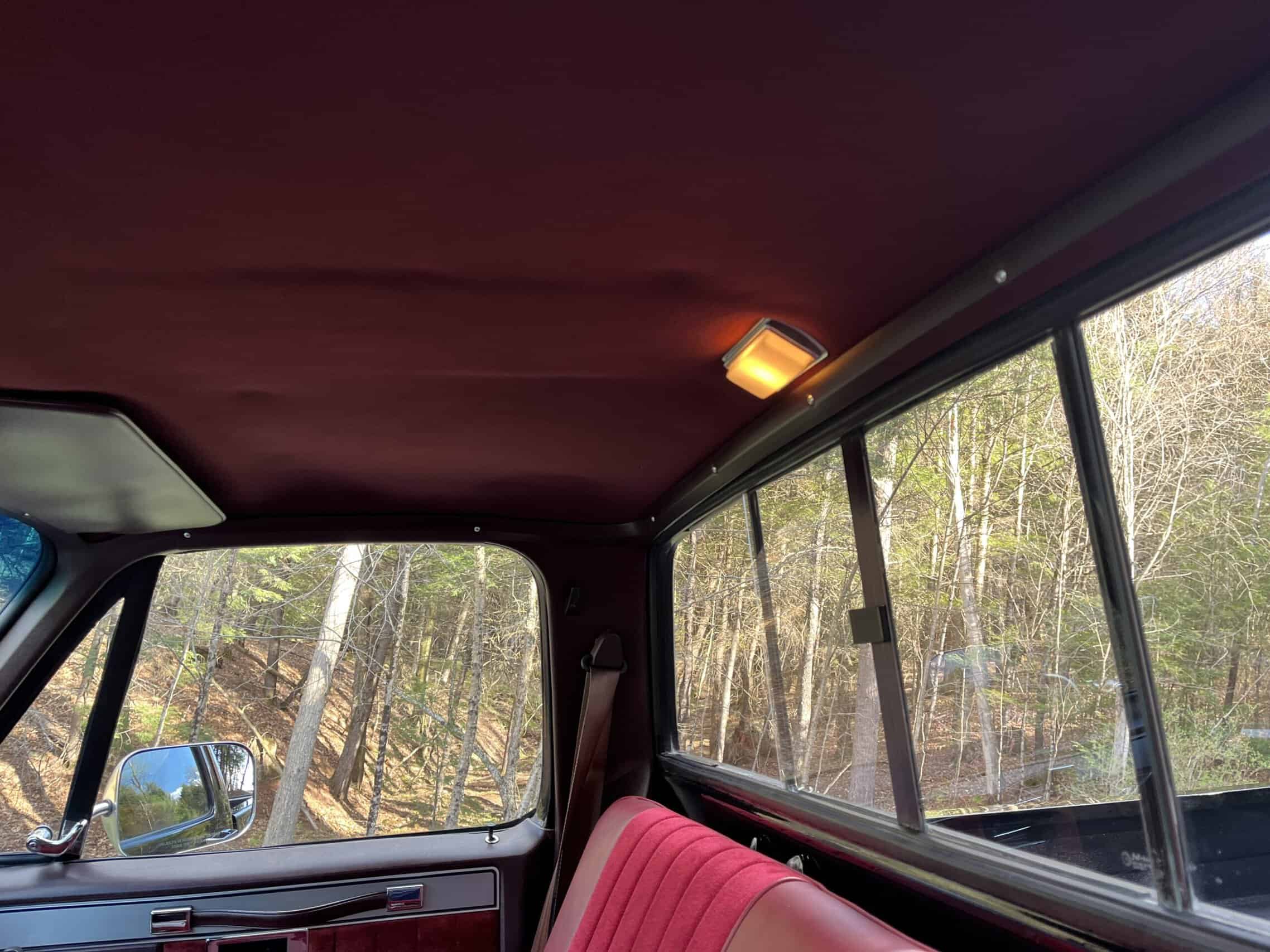 1986 Chevrolet SILVERADO — Interior shot of a classic car with pink seats and large windows.