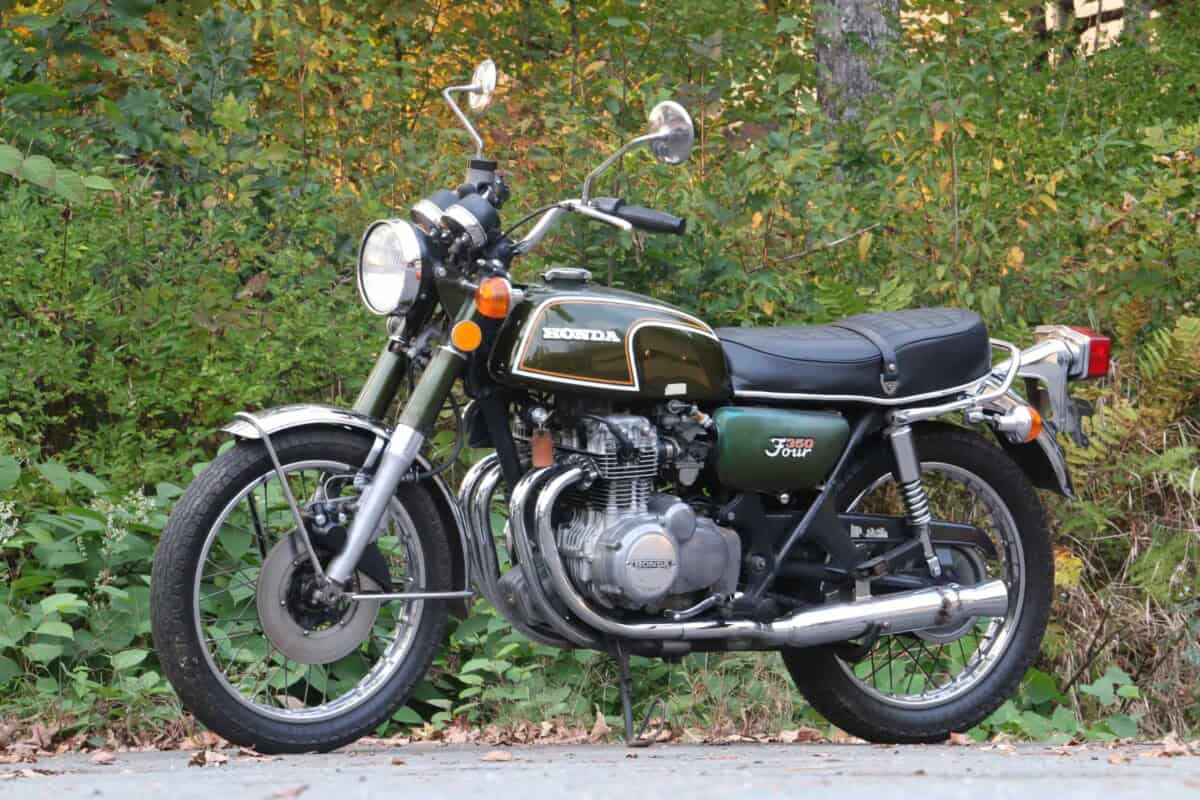 Side view of a black and chrome classic motorcycle on road.