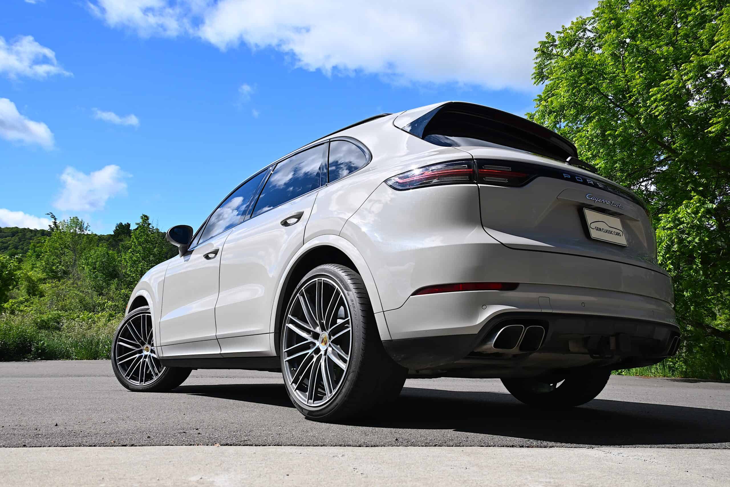 2022 Porsche Cayenne — White luxury SUV with sleek design and large wheels.