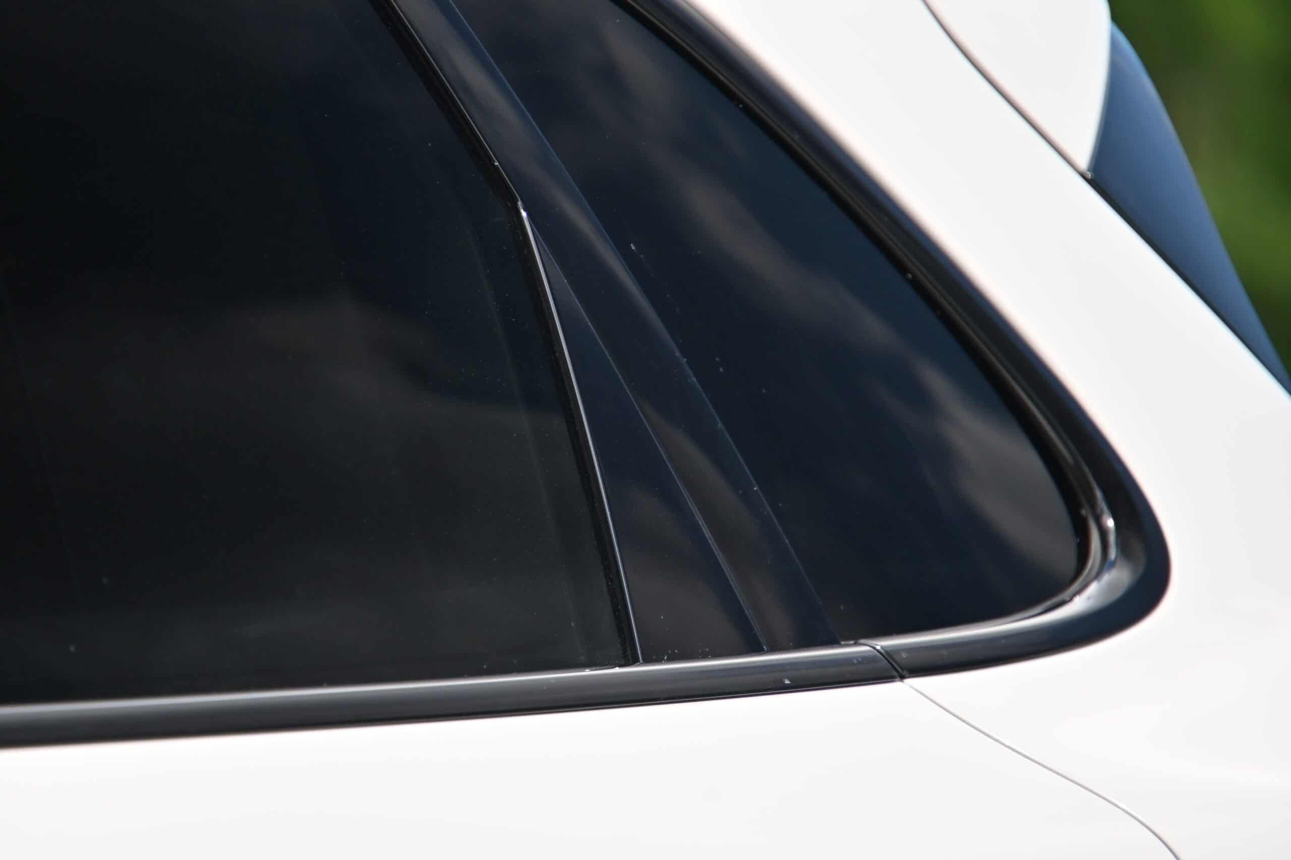 2022 Porsche Cayenne — Close-up of classic car window and body with black trim.