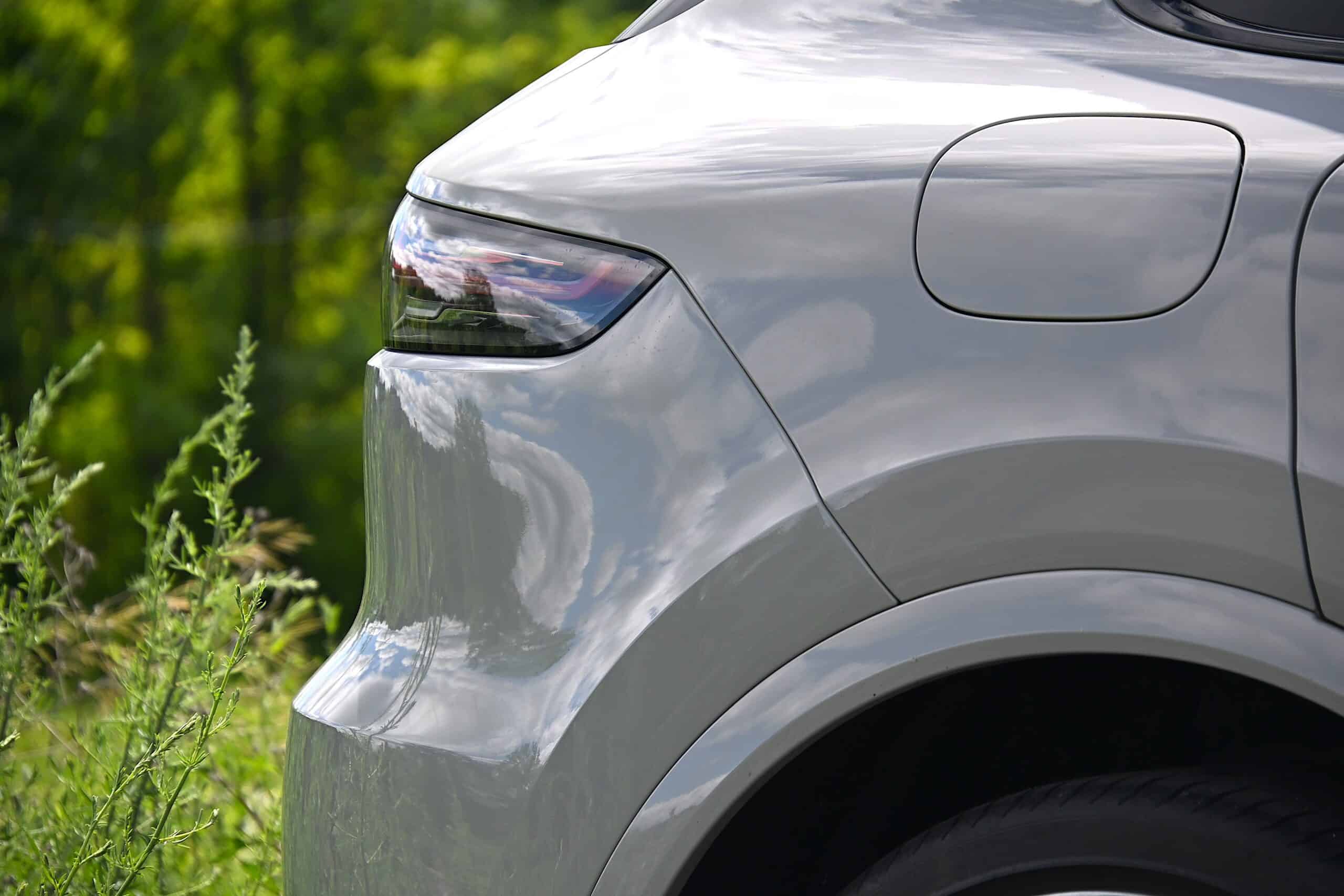 2022 Porsche Cayenne — Close-up of silver classic car body and wheel arch.