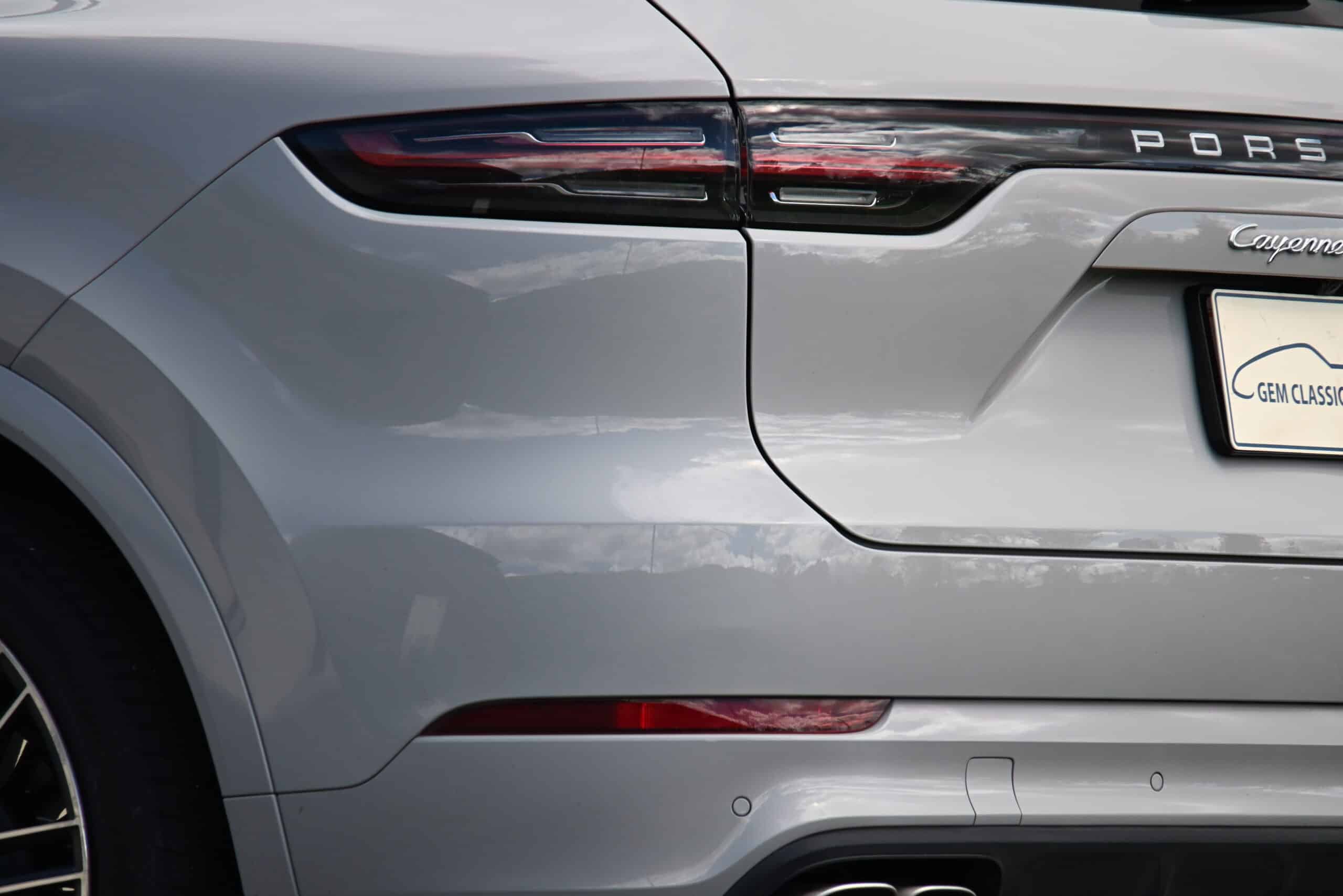 2022 Porsche Cayenne — Rear view of a silver classic car showing tail light and body details.