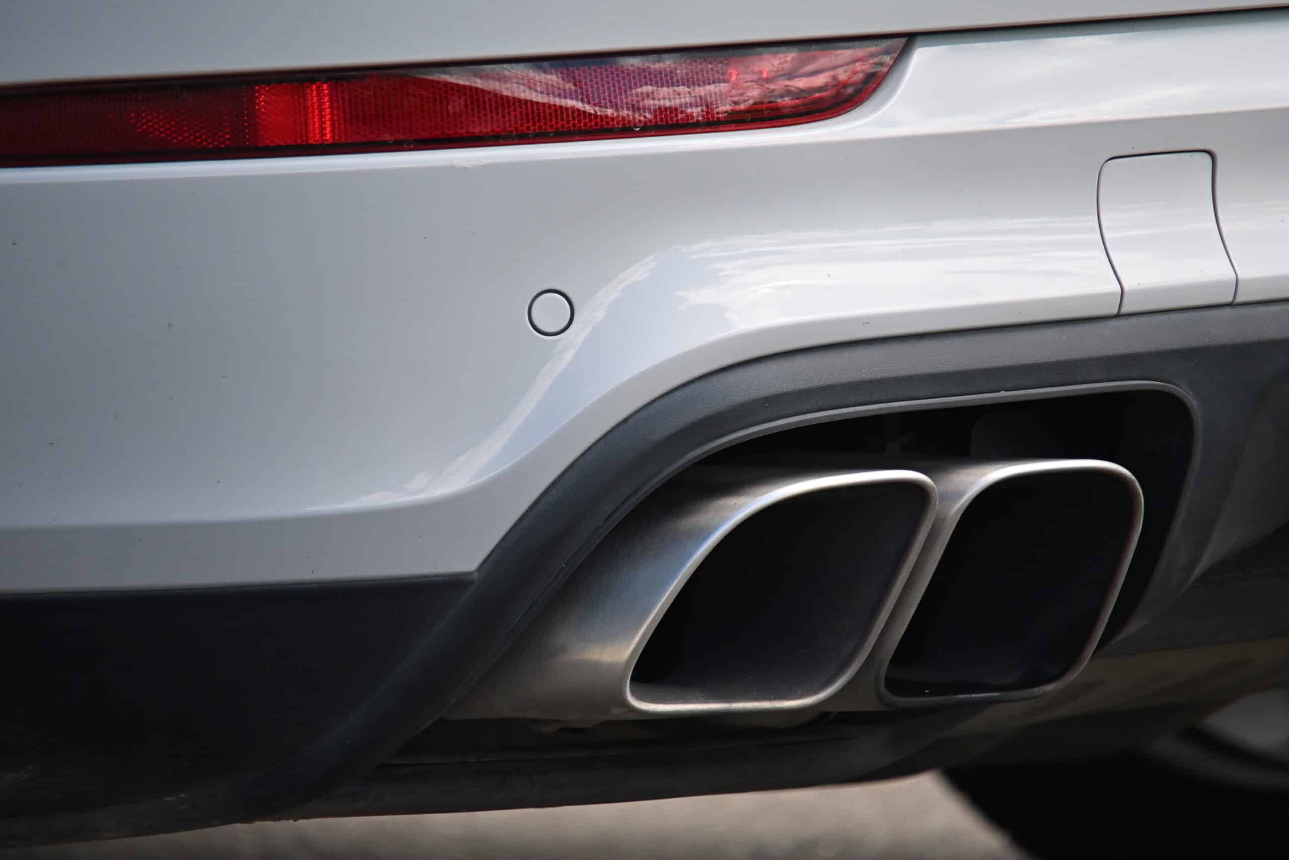 2022 Porsche Cayenne — Close-up of the rear exhaust pipes on a classic car.