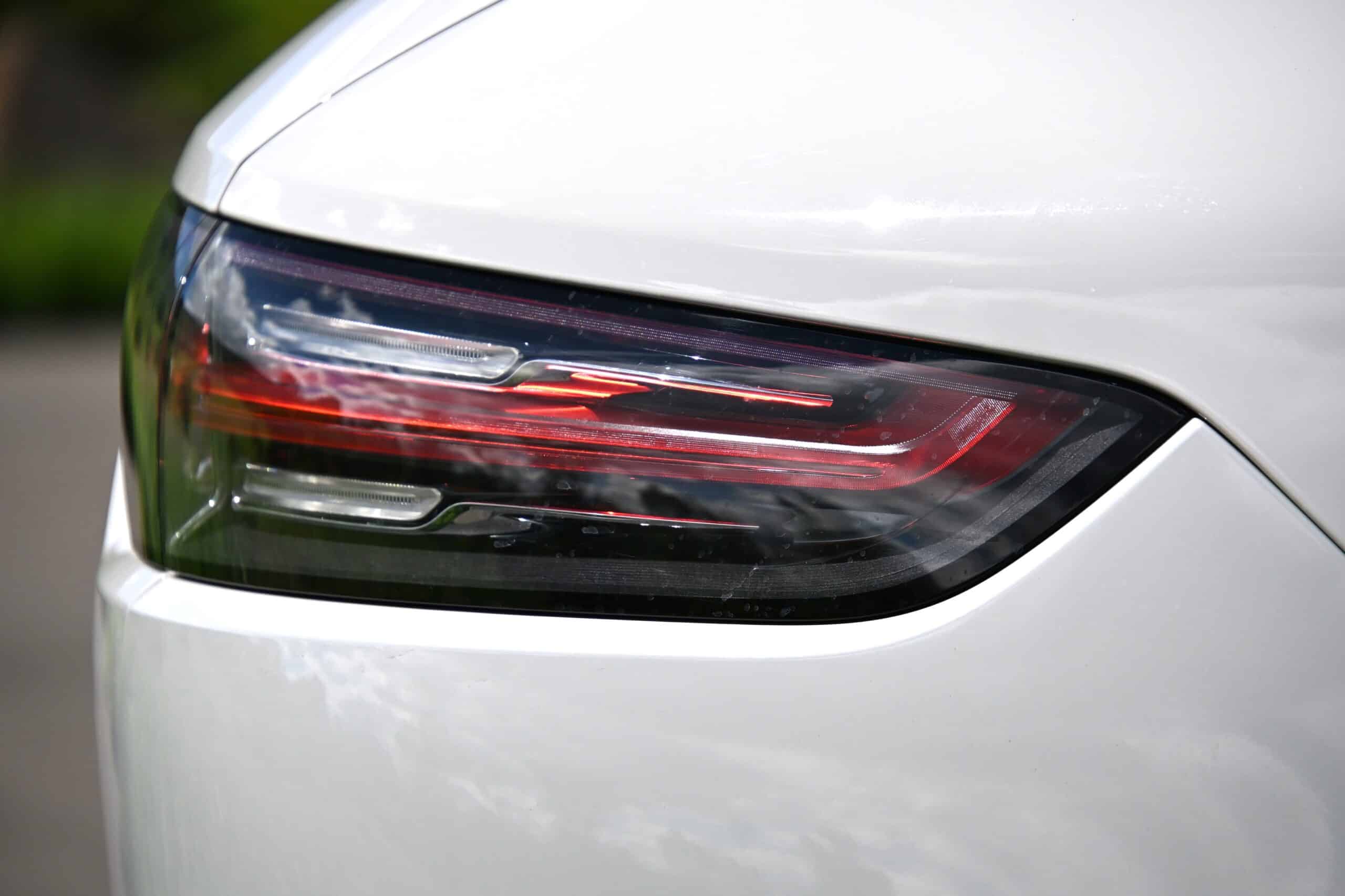 2022 Porsche Cayenne — Close-up of classic car tail light with sleek design and red accents.