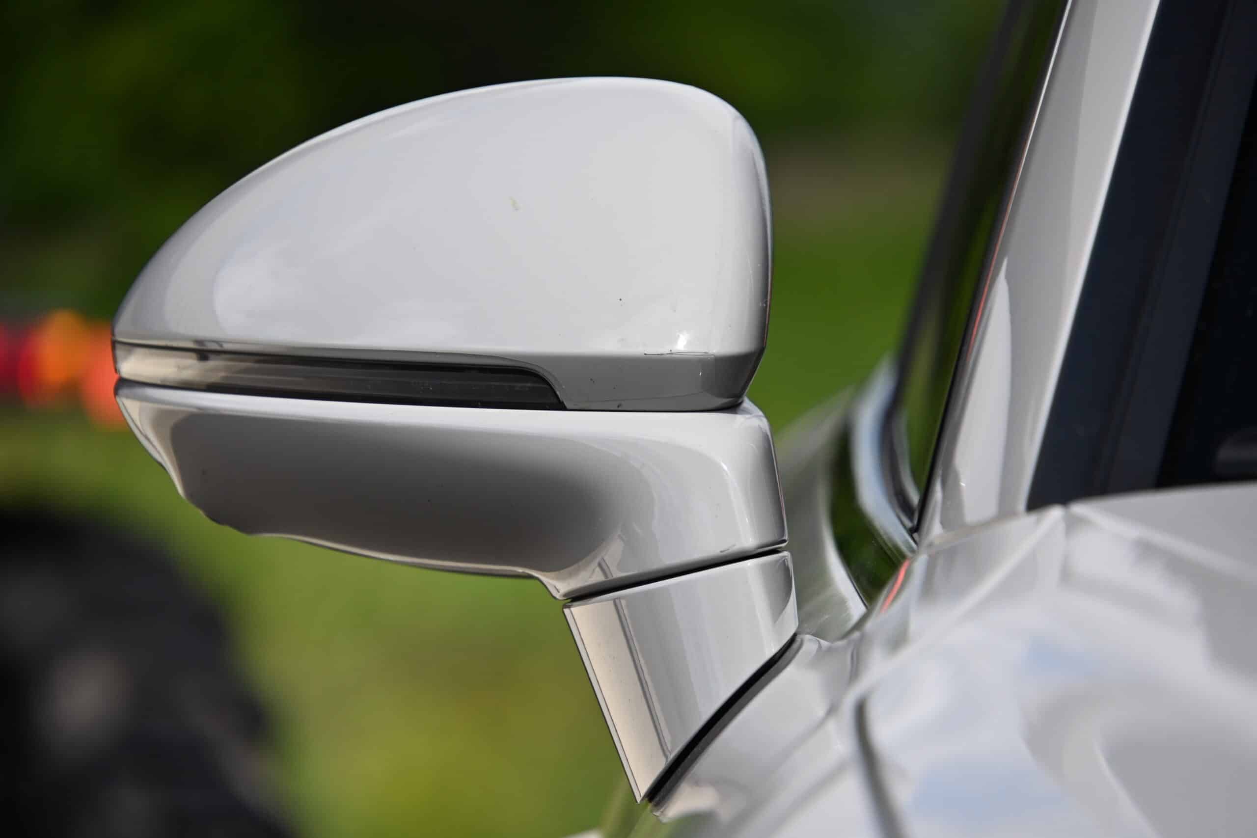 2022 Porsche Cayenne — Close-up of classic car side mirror on exterior shot.