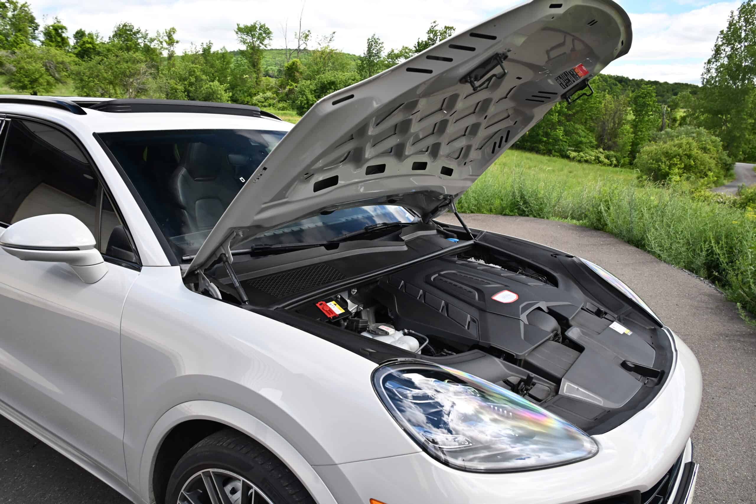 2022 Porsche Cayenne — Exterior shot of a classic car with open hood showing engine bay.