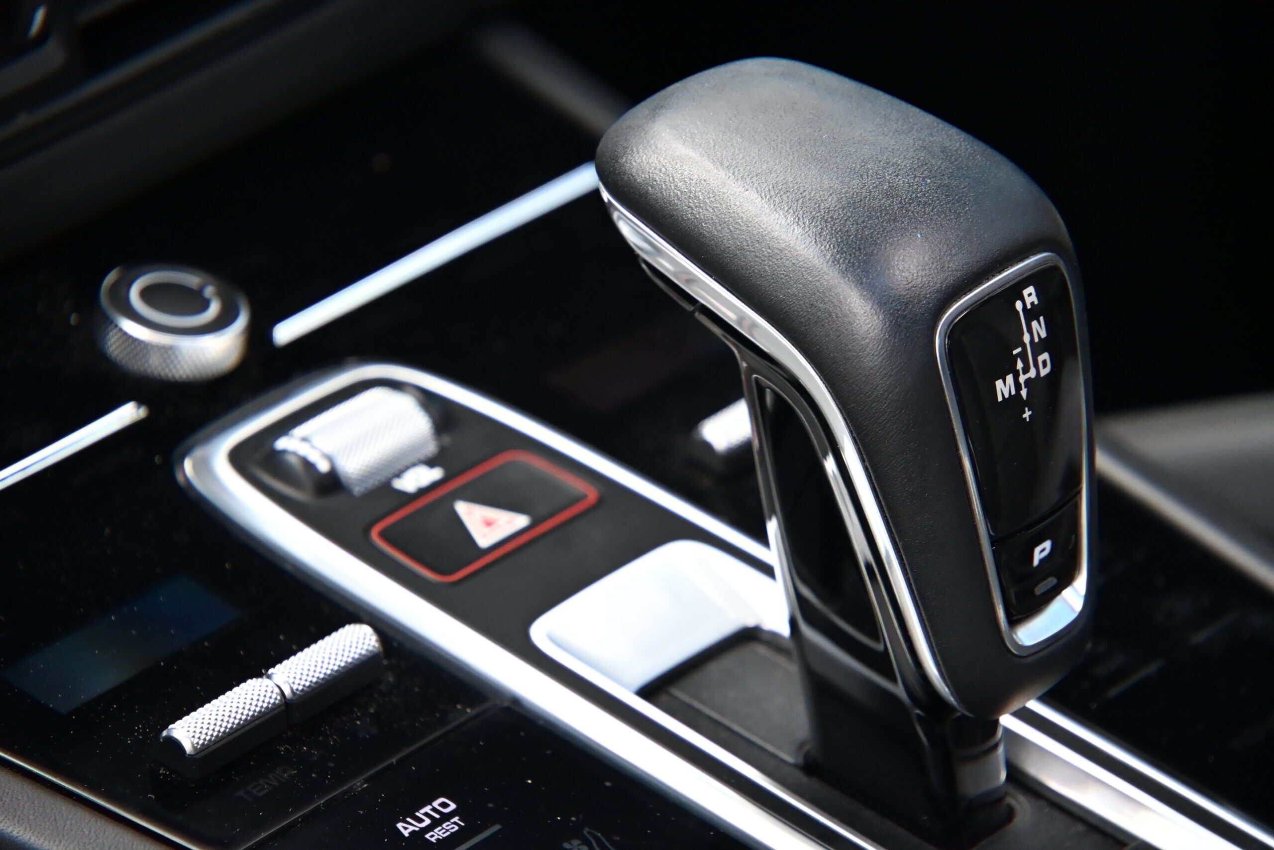 2022 Porsche Cayenne — Close-up of automatic gear shift and control buttons in a modern car.