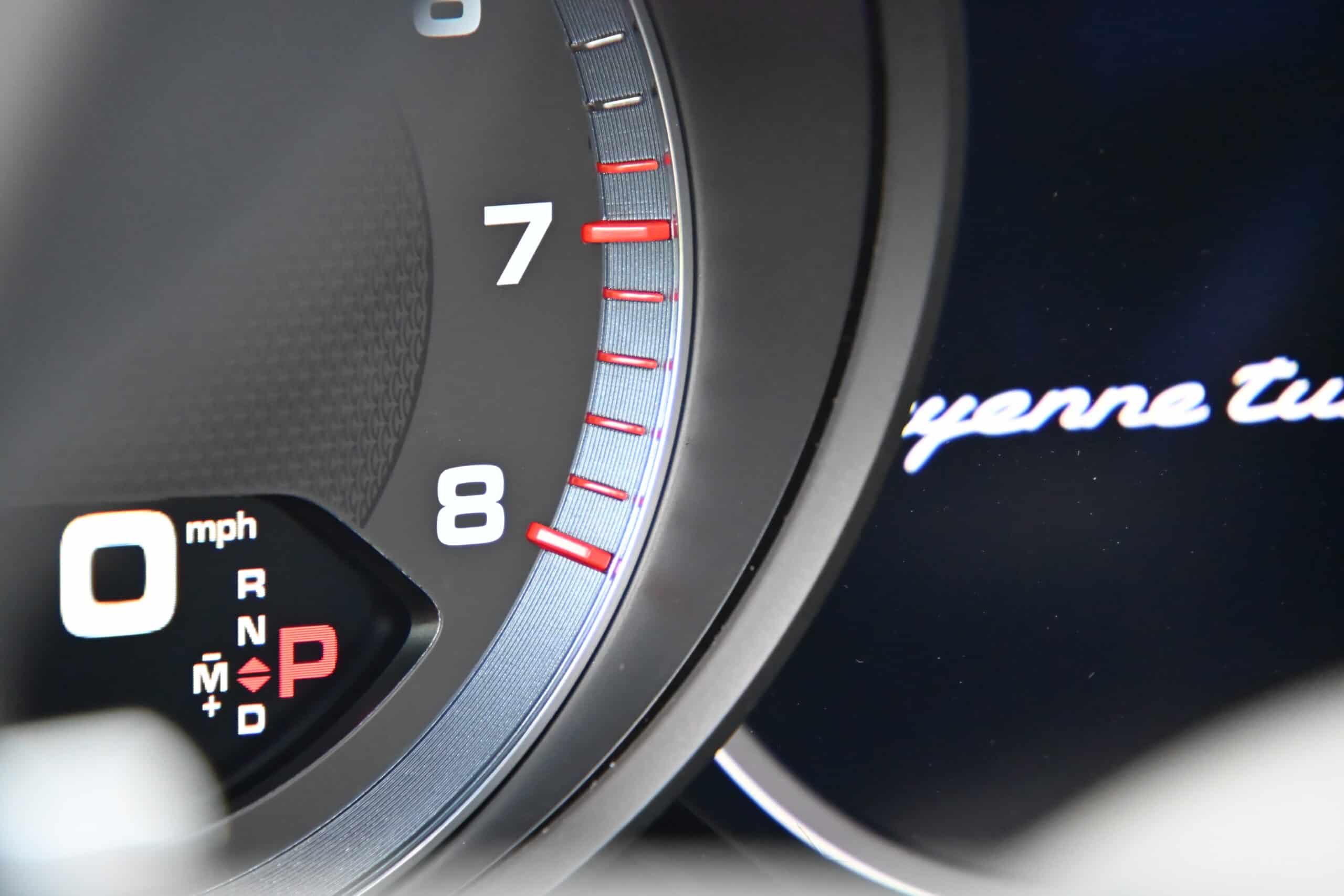 2022 Porsche Cayenne — Dashboard of a classic car showing speedometer and digital display.