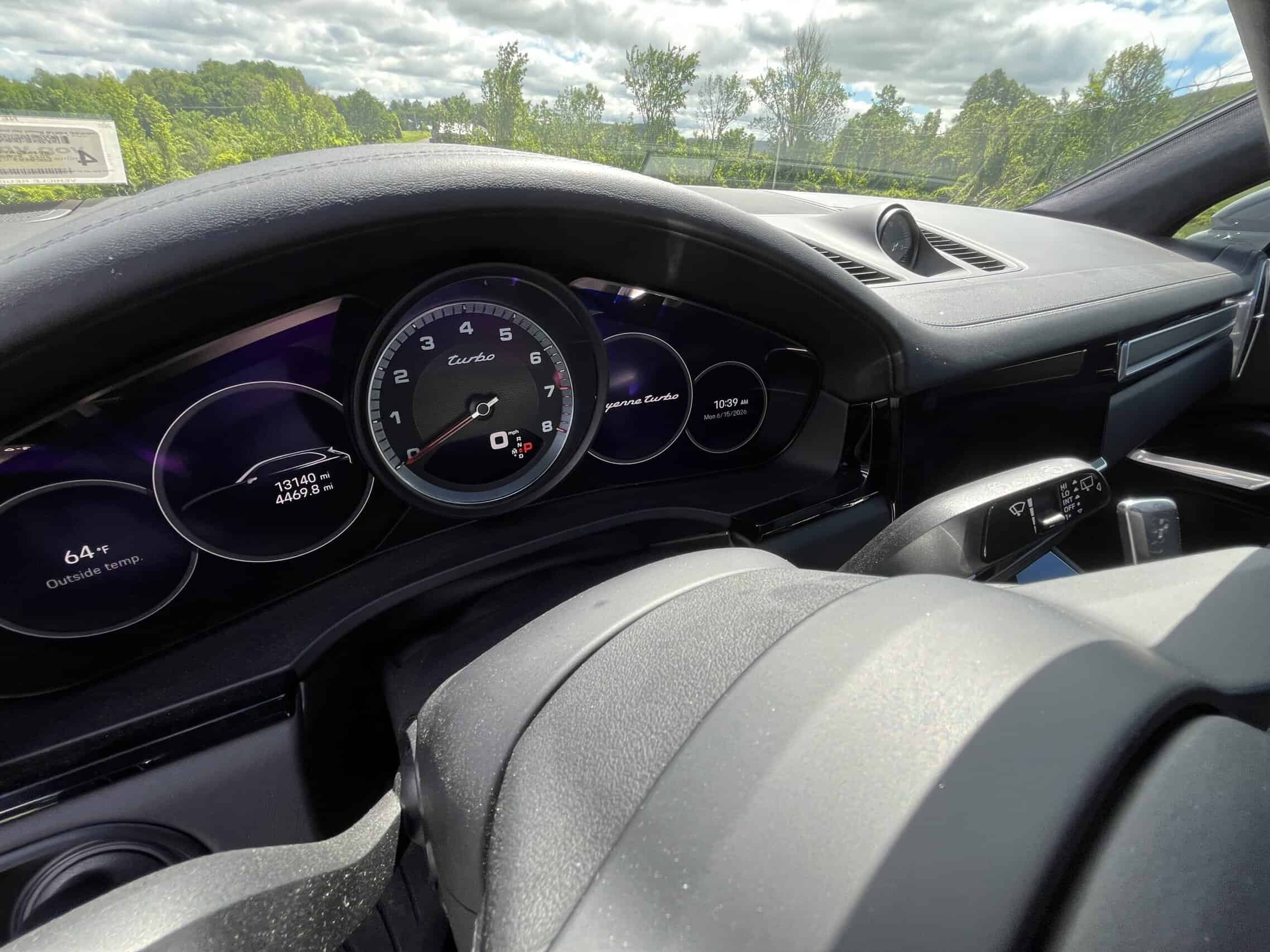 2022 Porsche Cayenne — Close-up of classic car interior dashboard with speedometer and controls.