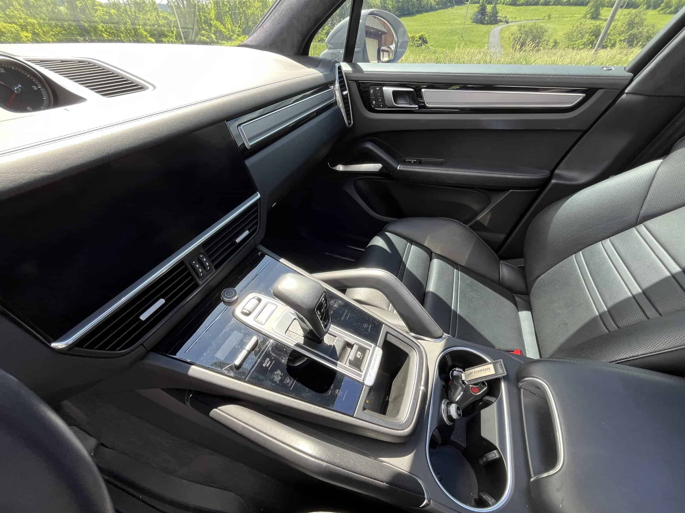 2022 Porsche Cayenne — Interior shot of a classic car showing dashboard and gear shift.