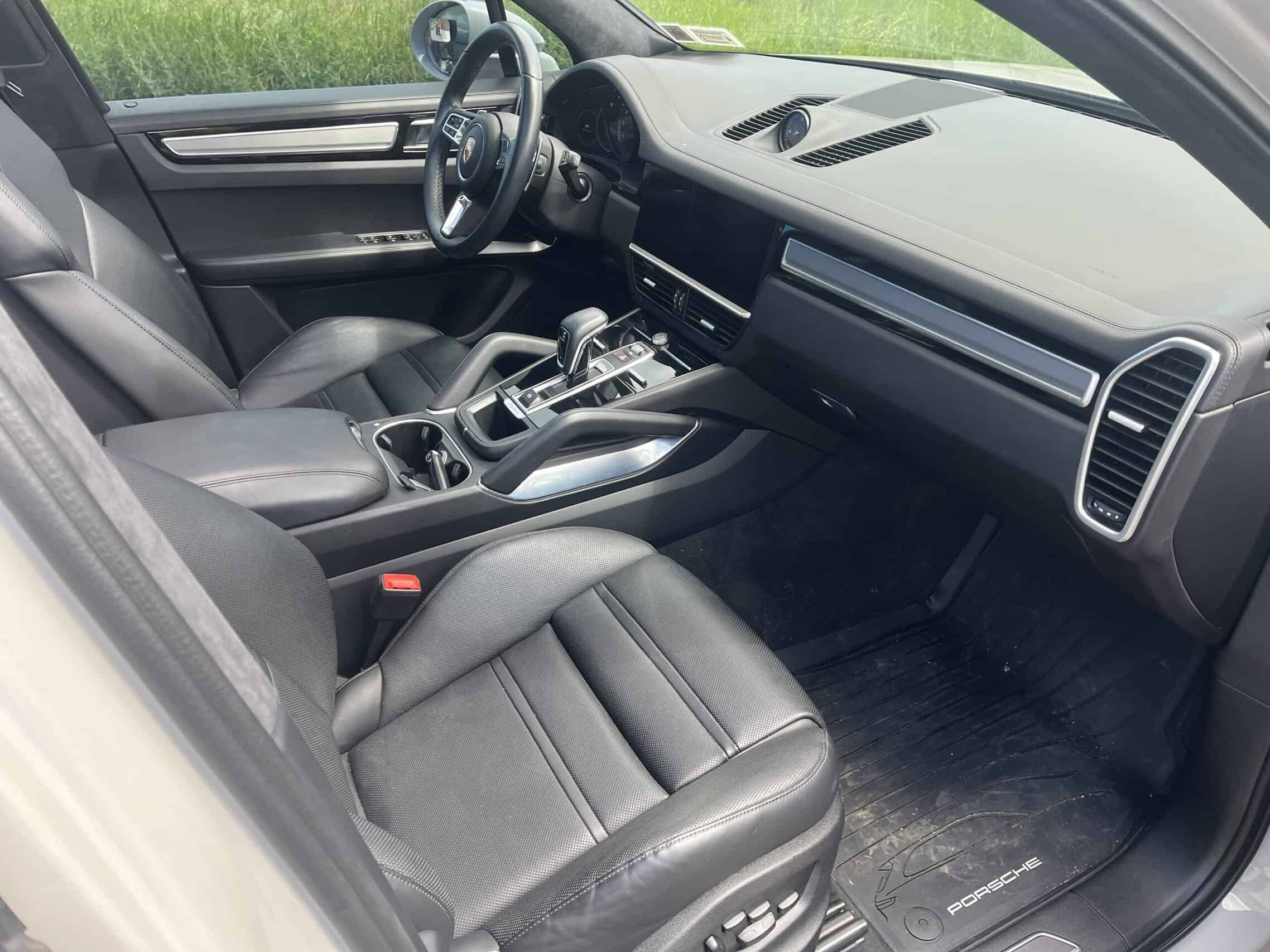 2022 Porsche Cayenne — Interior shot of a modern car with leather seats and dashboard.