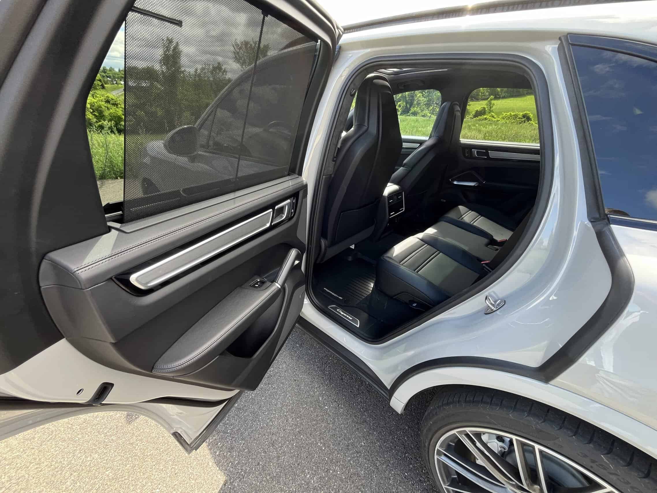 2022 Porsche Cayenne — Interior view of a classic car with open door and black seats.