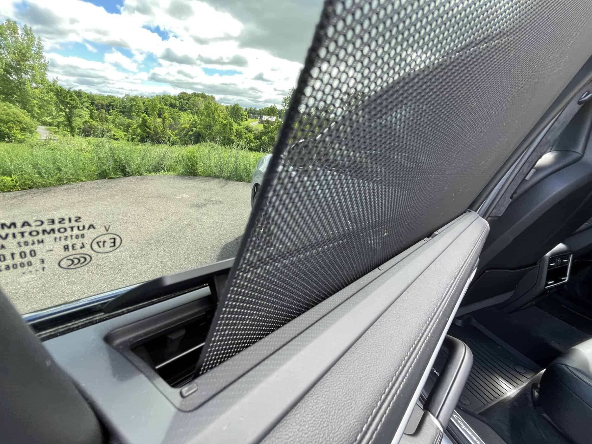 2022 Porsche Cayenne — Interior shot of a classic car with sunshade and dashboard features.