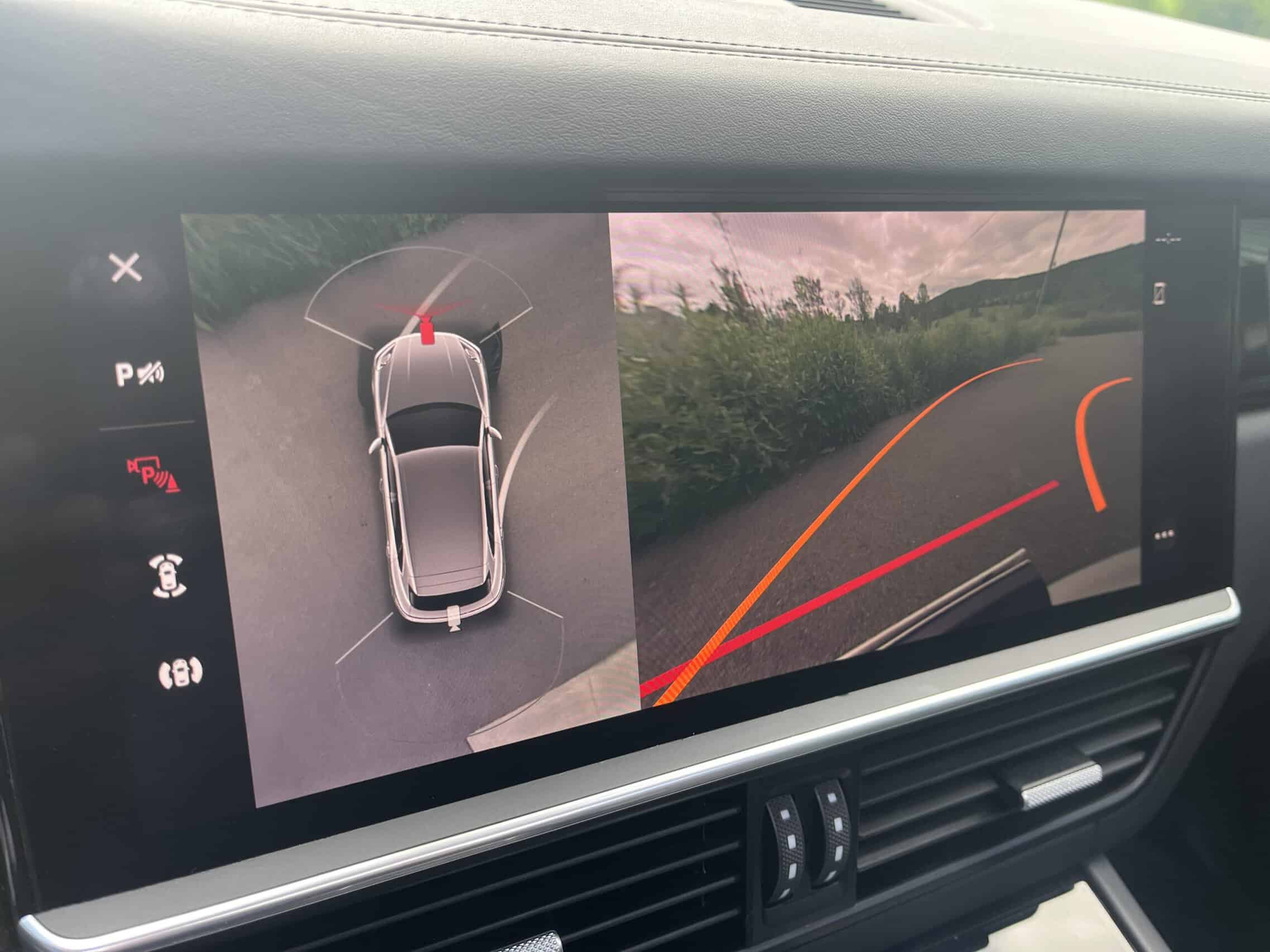 2022 Porsche Cayenne — Interior shot of a classic car showing backup camera display with parking lines.