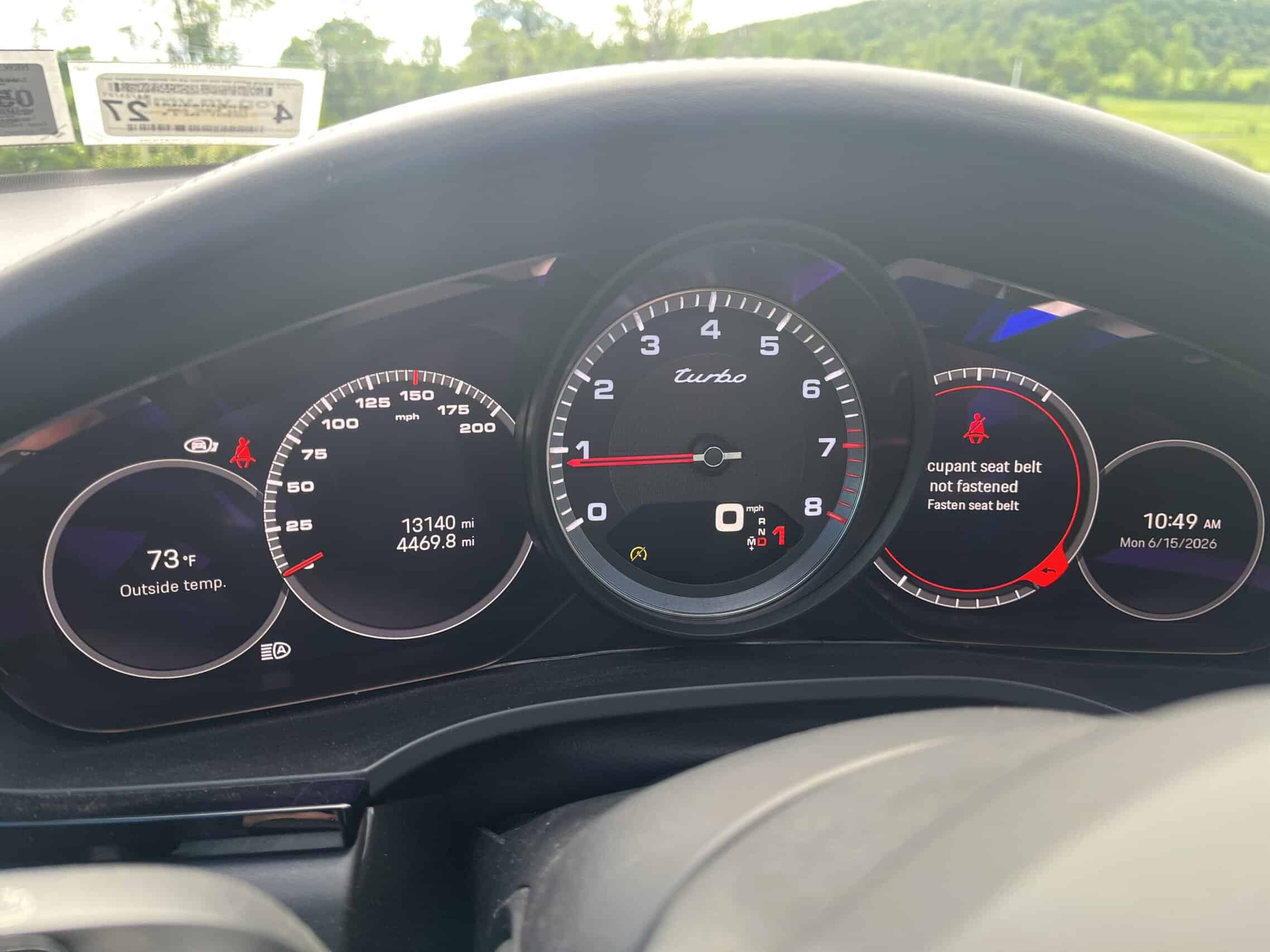 2022 Porsche Cayenne — Close-up of classic car dashboard showing tachometer and speedometer.