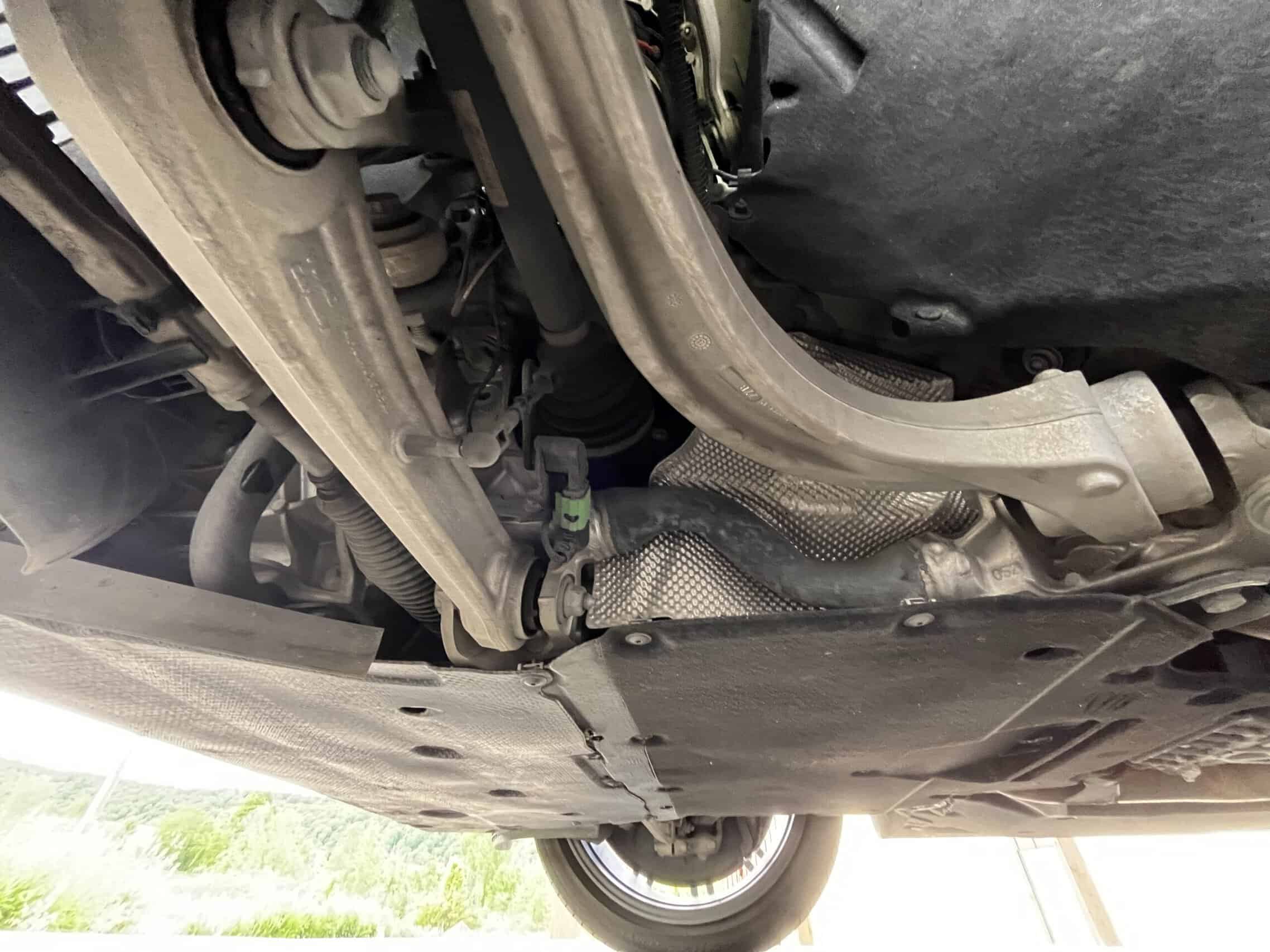 2022 Porsche Cayenne — View of the underside of a classic car showing exhaust and suspension parts.