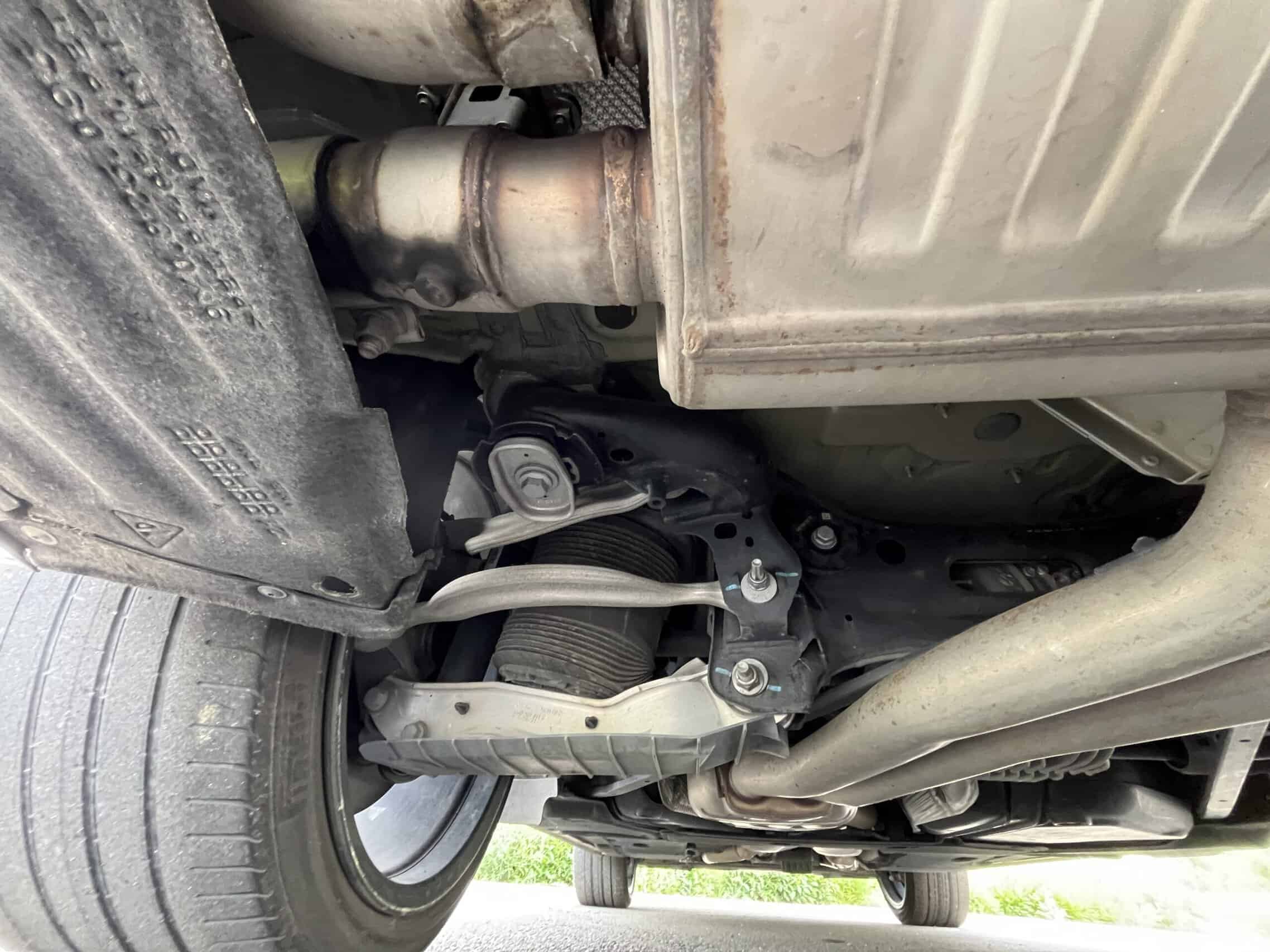 2022 Porsche Cayenne — Underneath view of classic car engine and exhaust system.