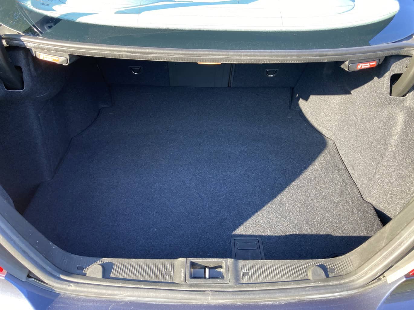 1999 Mercedes CLK500 — Open trunk of a classic car showing spacious interior and carpeted floor.