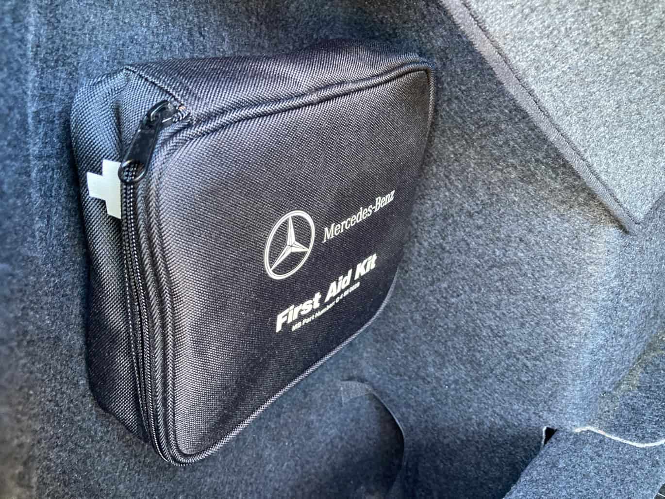 1999 Mercedes CLK500 — Black Mercedes-Benz travel bag in car trunk with logo visible.