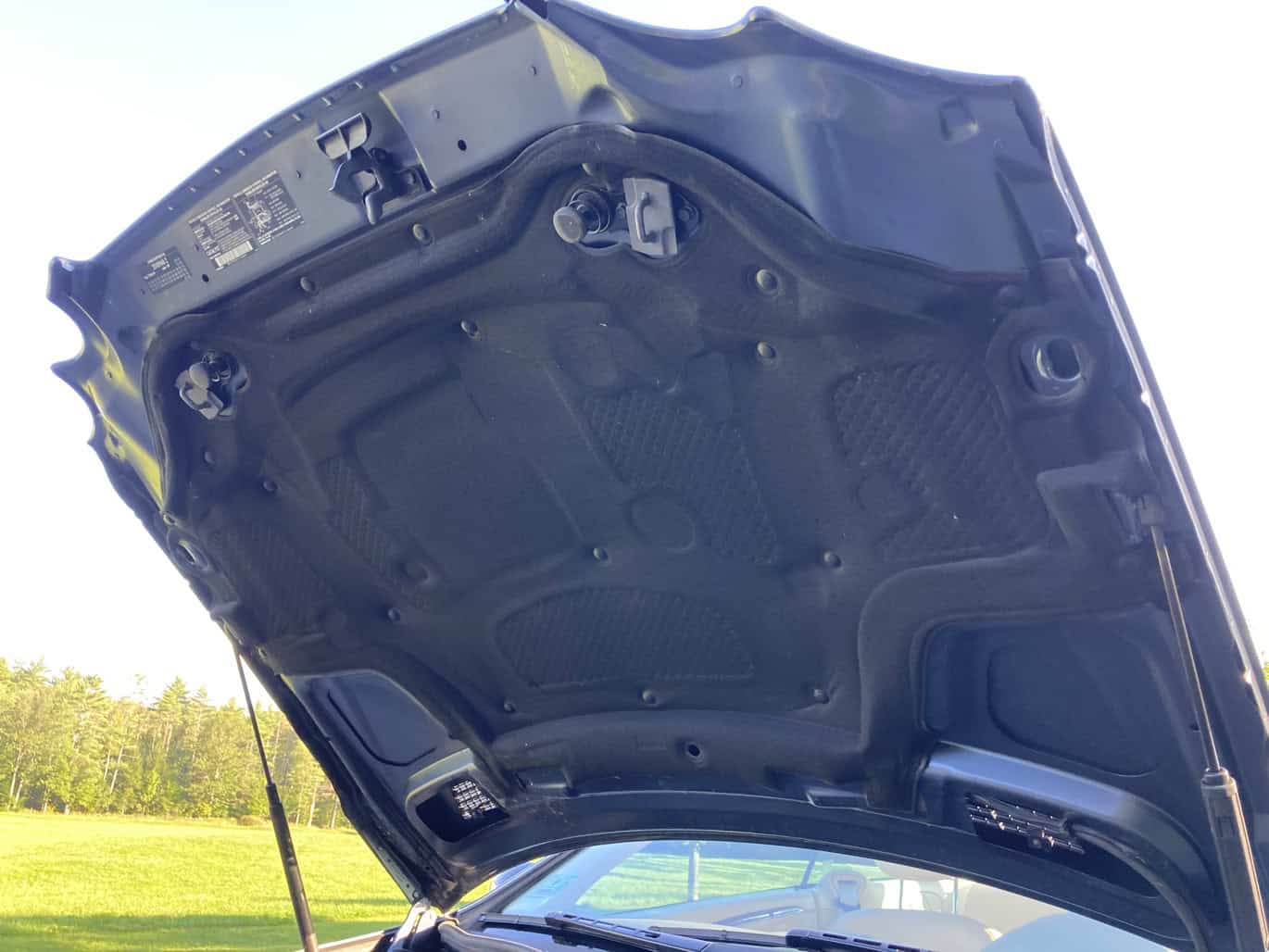 1999 Mercedes CLK500 — Engine bay of a classic car with open hood and visible components.