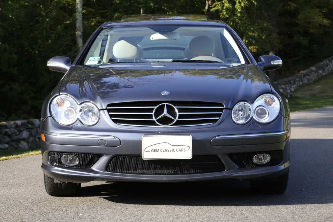1999 Mercedes CLK500 — Front view of a classic car with Mercedes emblem and round headlights.