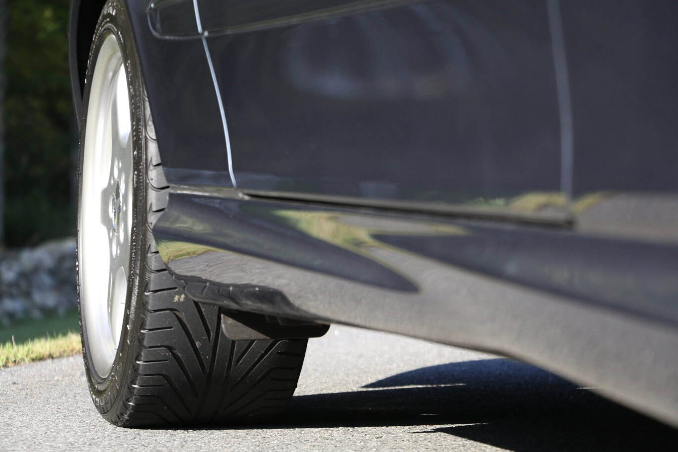 1999 Mercedes CLK500 — Close-up of the rear wheel and side of a classic car.