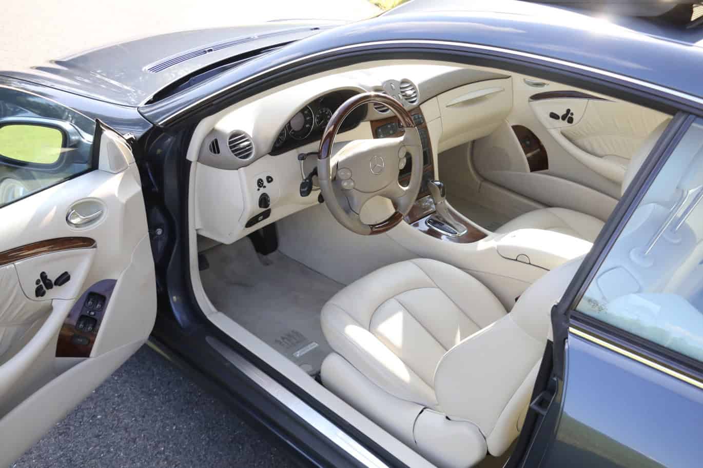 1999 Mercedes CLK500 — Interior view of a classic car with leather seats and dashboard.