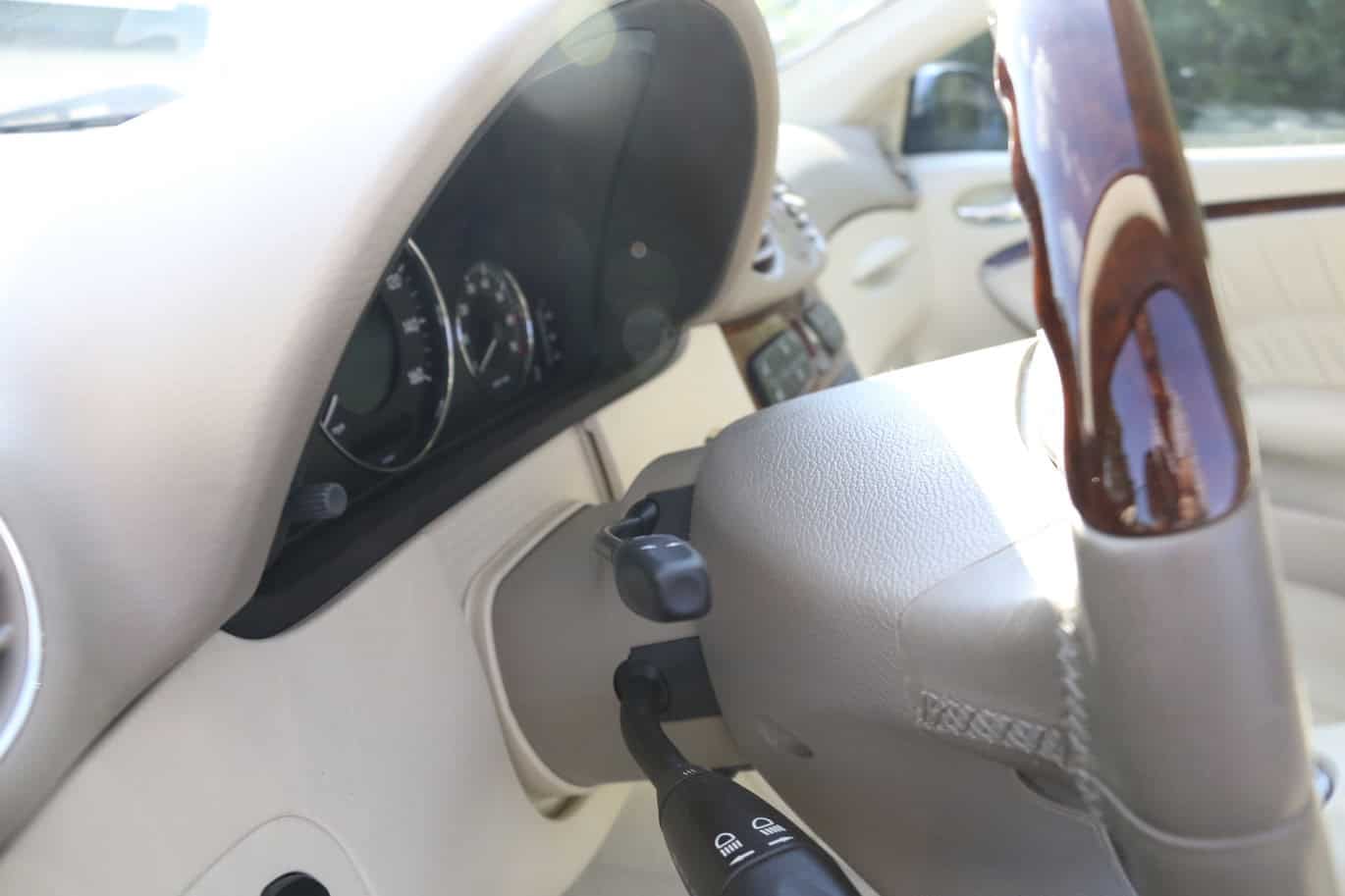 1999 Mercedes CLK500 — Close-up of classic car interior with dashboard and steering wheel.