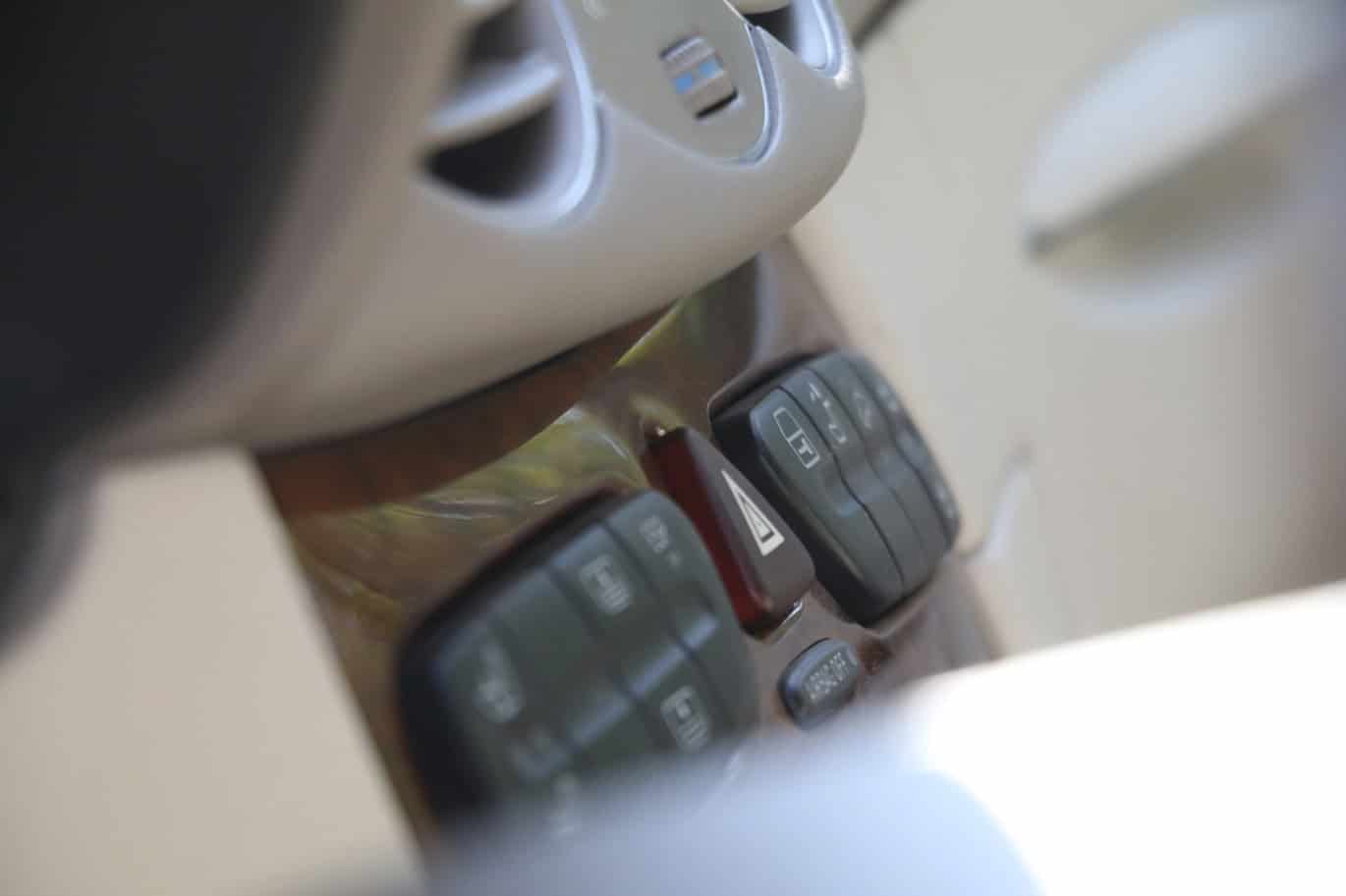 1999 Mercedes CLK500 — Close-up of classic car interior dashboard with controls.