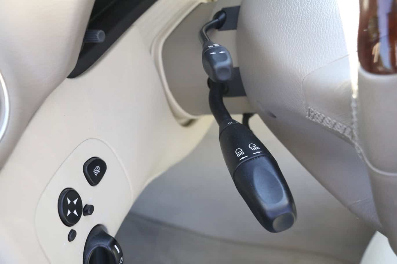 1999 Mercedes CLK500 — Close-up of interior switch and control panel in classic car.