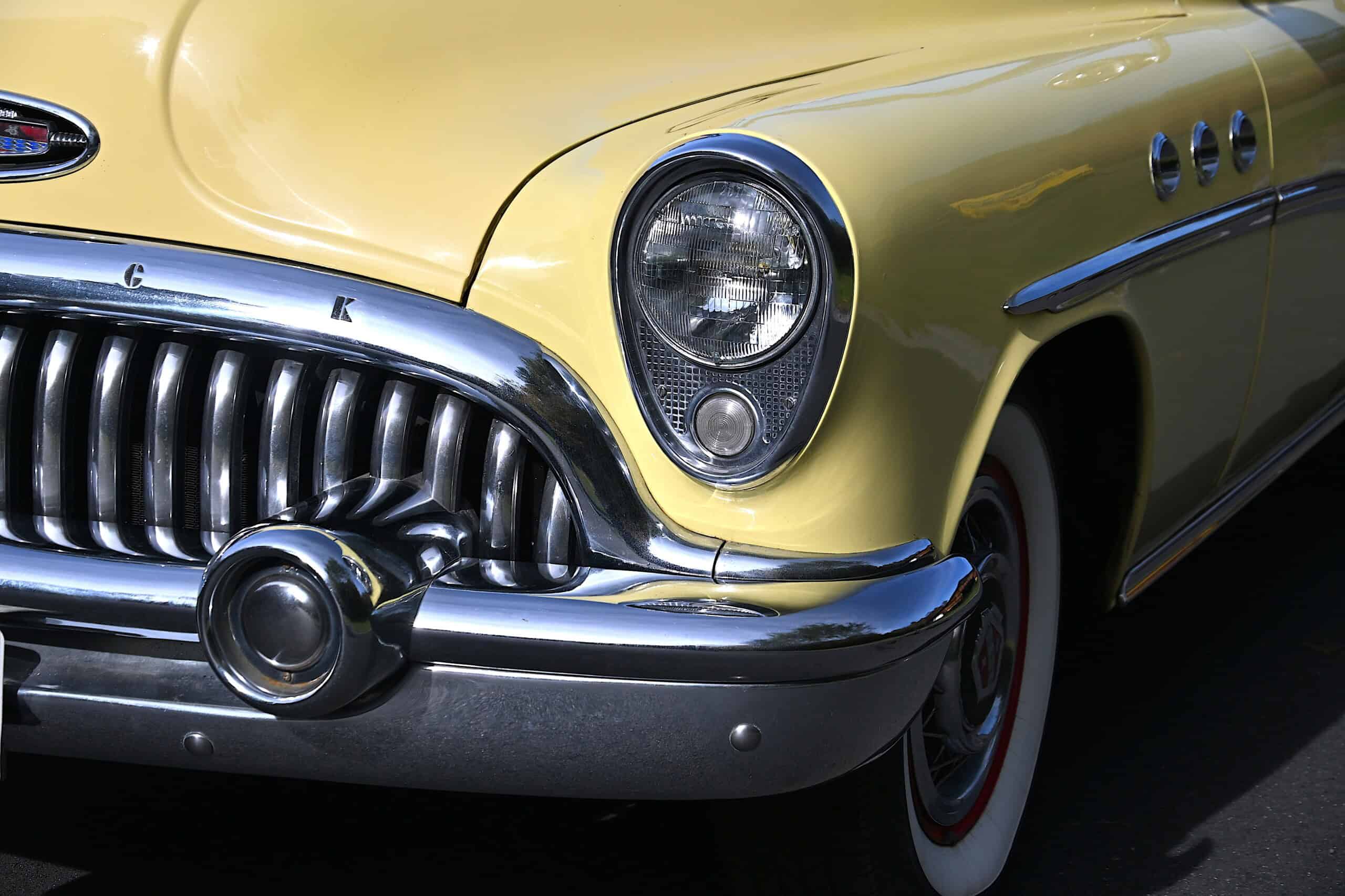 1953 Buick special — Close-up of classic car's front with chrome grille and headlight.