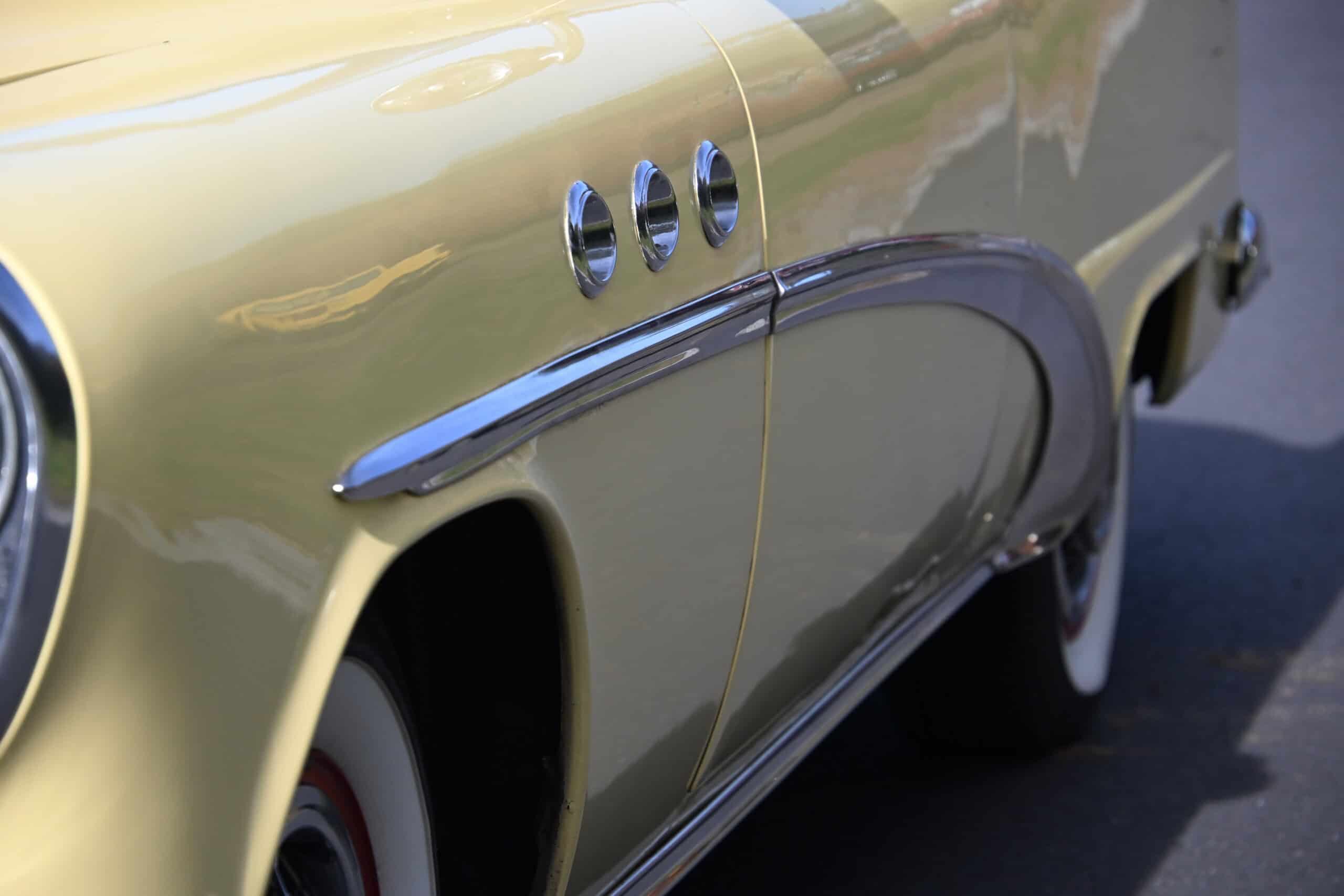 1953 Buick special — Close-up of classic car's side with chrome accents and yellow paint.