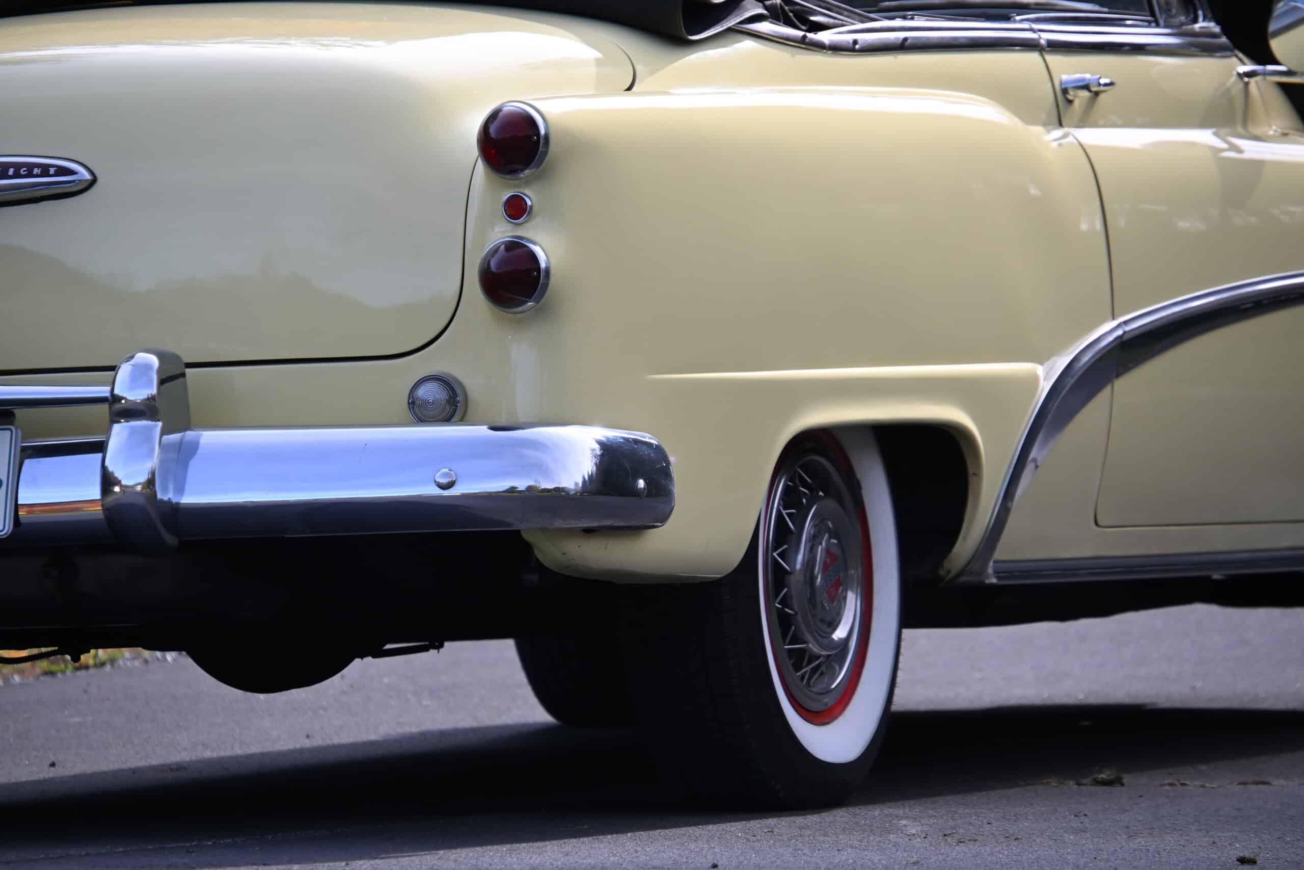 1953 Buick special — Rear view of a classic car with yellow paint and whitewall tire.