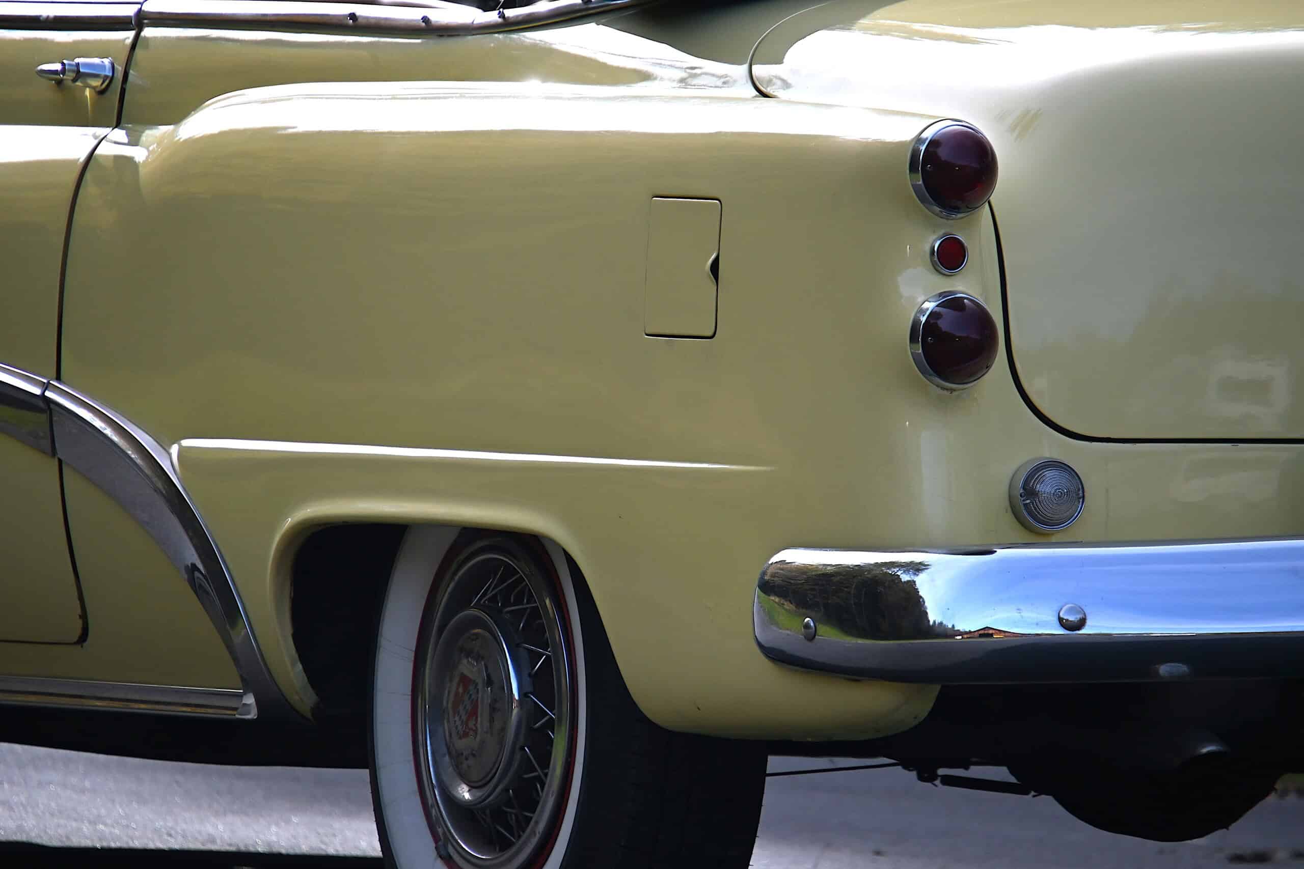 1953 Buick special — Rear view of a yellow classic car with tail lights and chrome bumper.