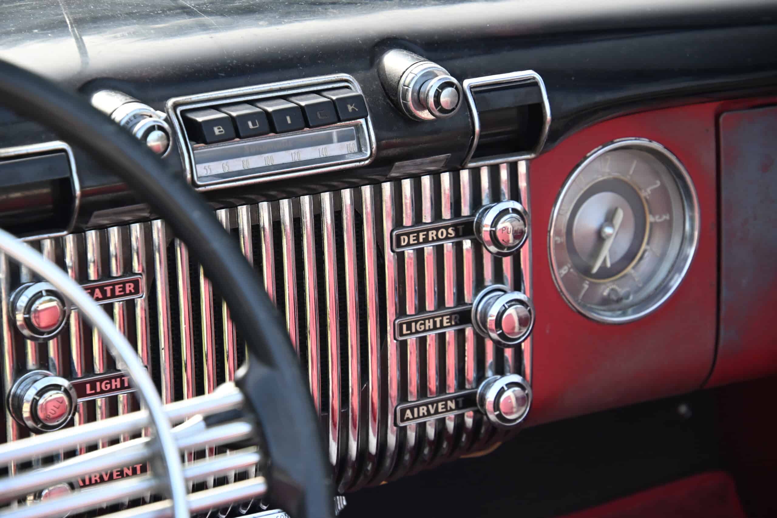 1953 Buick special — Interior dashboard of a classic car with controls and clock.