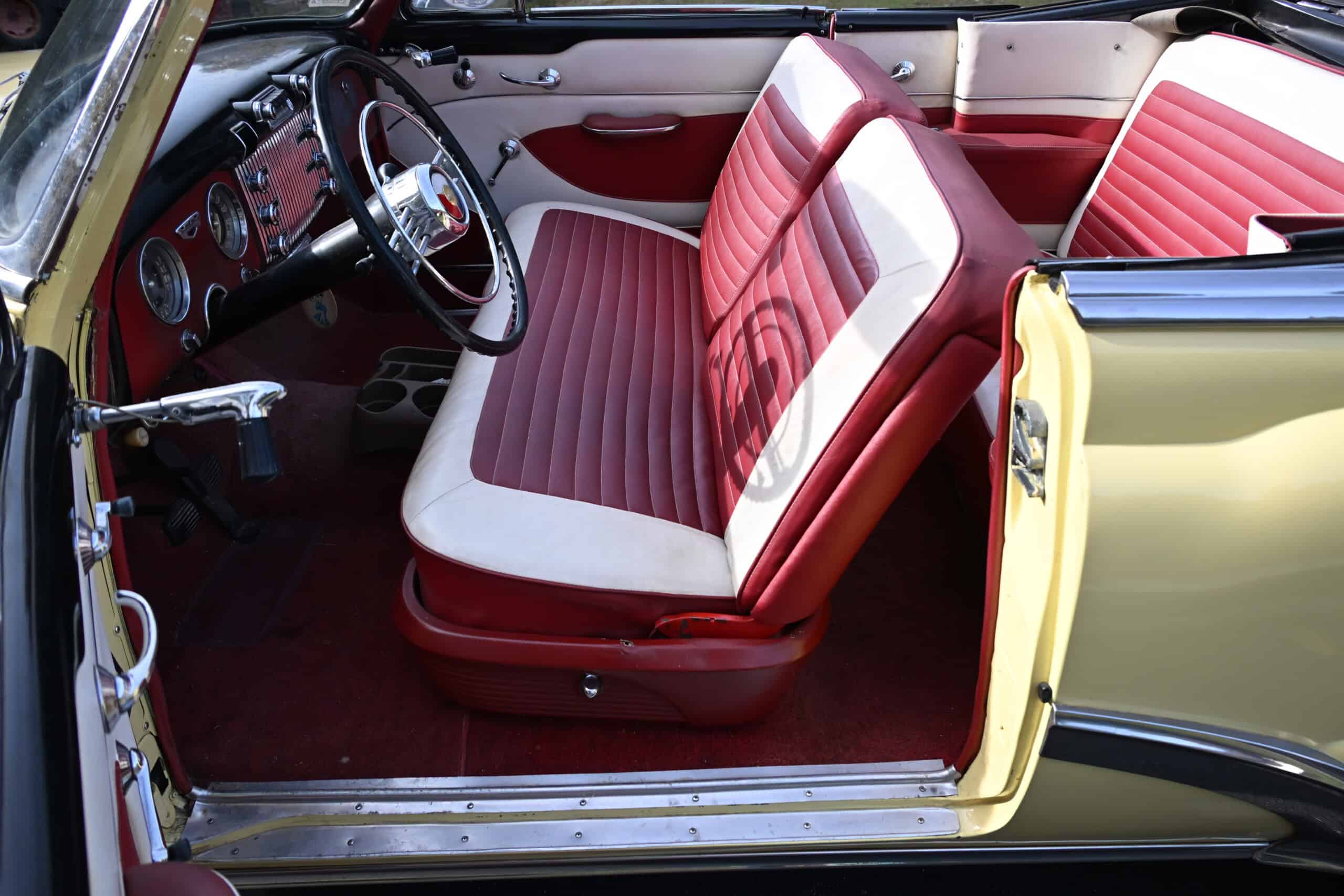 1953 Buick special — Interior shot of a classic car with red and white bench seats.