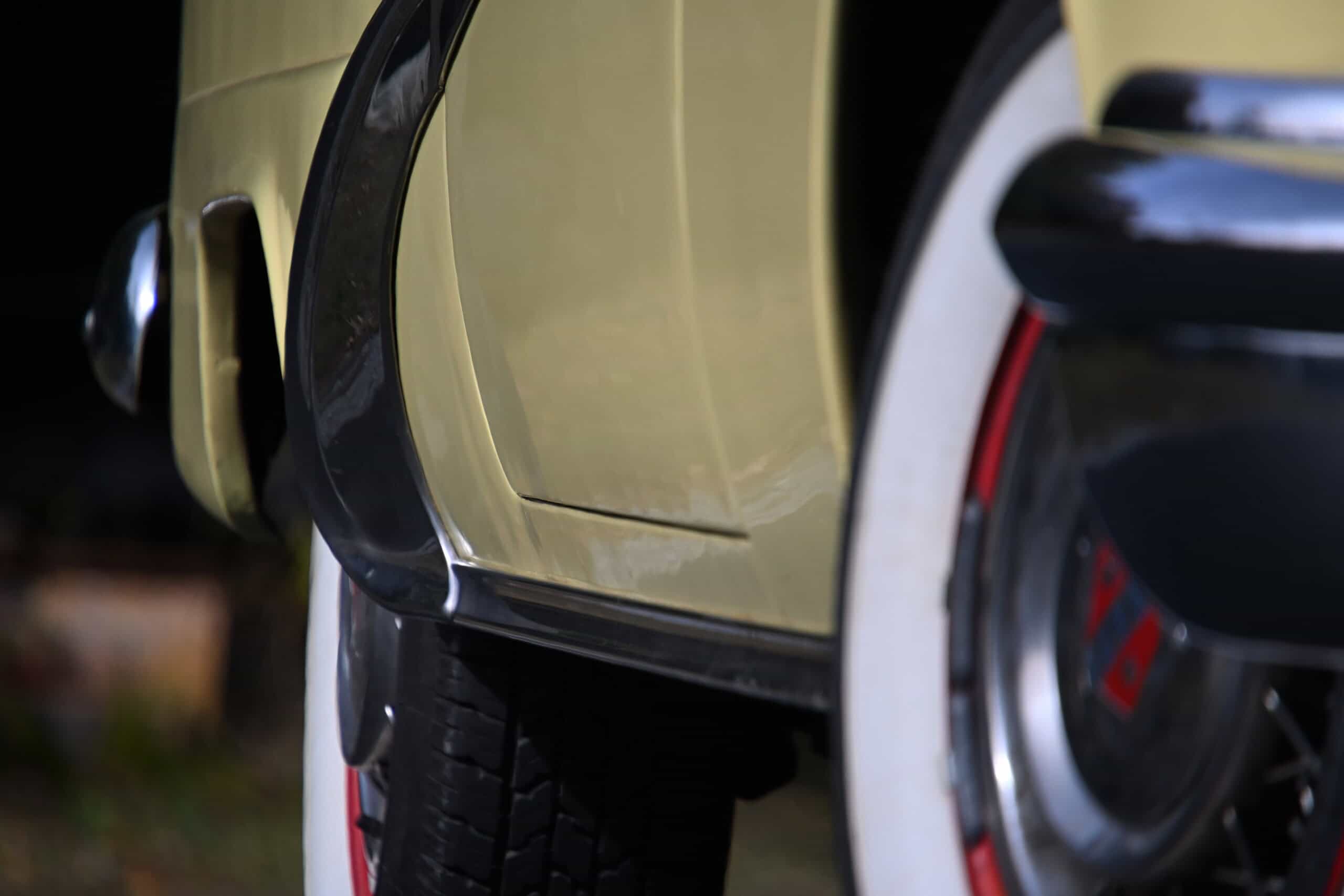 1953 Buick special — Close-up of classic car door and wheel with black tire.