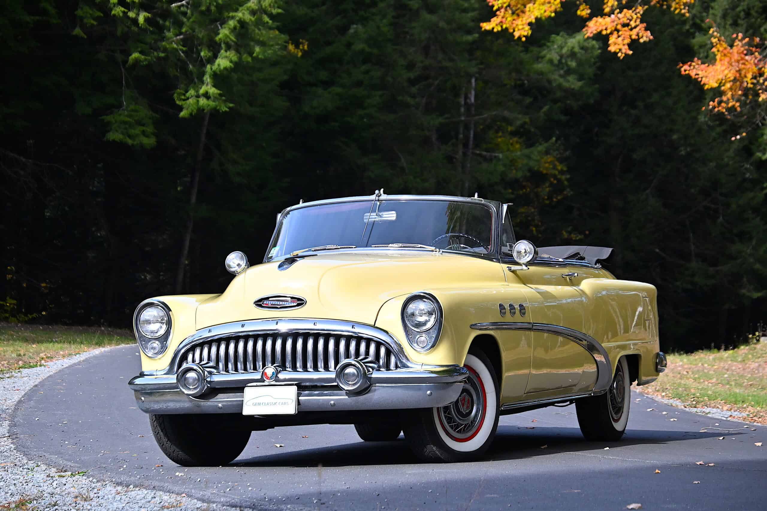 1953 Buick special — Yellow classic car convertible with black interior on curved road.