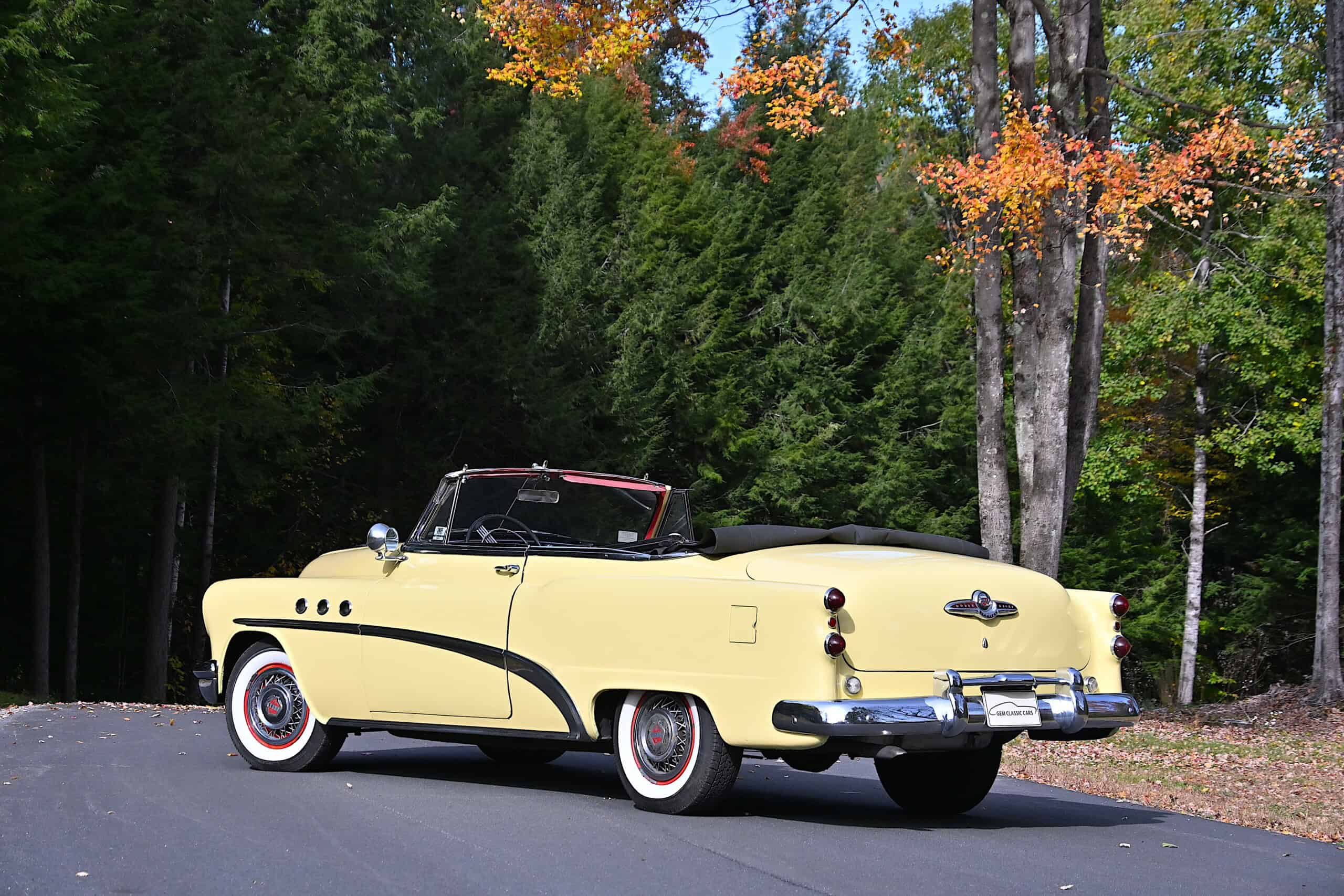 1953 Buick special — Exterior shot of a yellow classic car convertible with black interior.