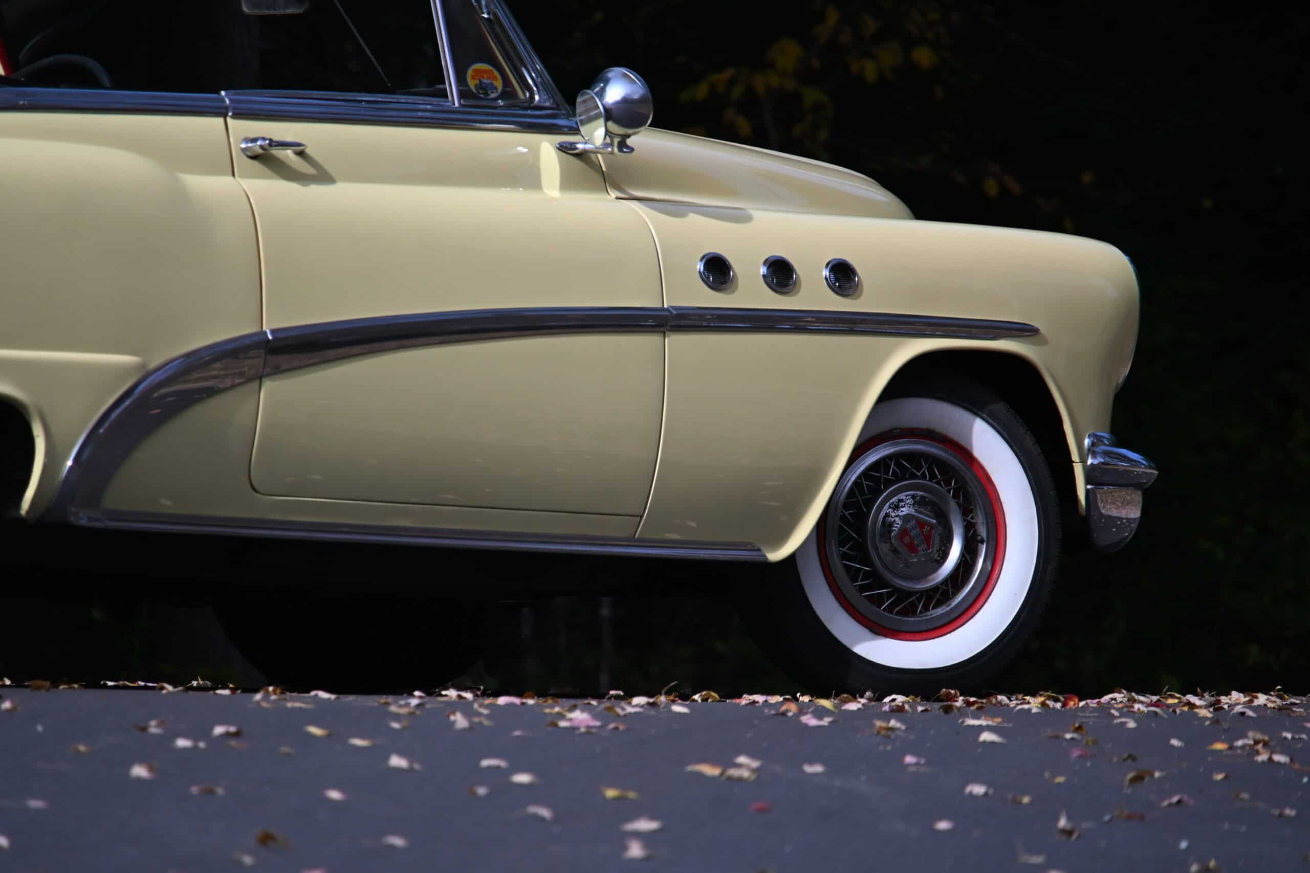 1953 Buick special — Side view of a classic car with beige body and whitewall tire.