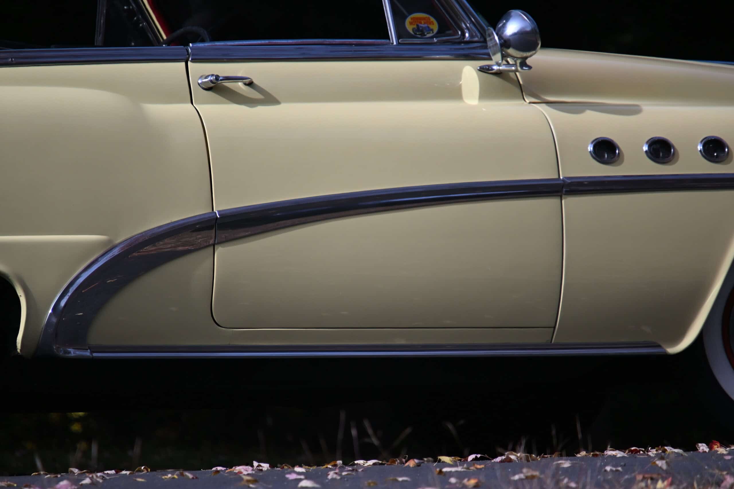1953 Buick special — Close-up of classic car door and chrome trim with beige paint.